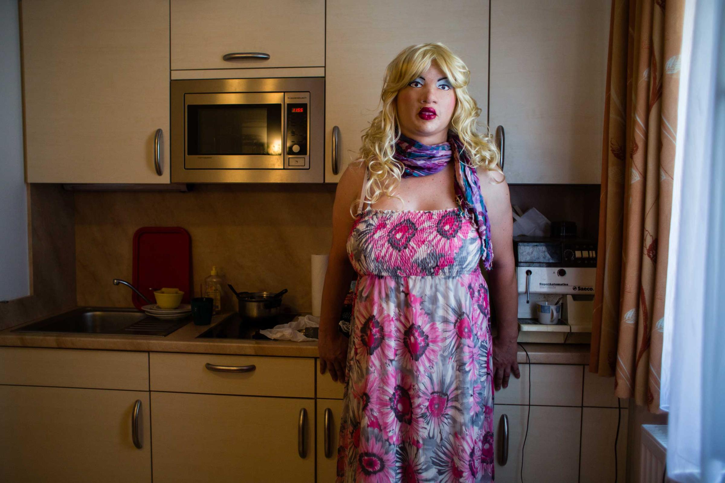 MUNICH, GERMANY - AUGUST 04, 2015: Portrait of female masker and transsexual woman 'Bear Girl', 39, in her kitchen, August 04, 2015 in Munich, Germany. "My biggest dream is to be a beautiful woman. I am not a topmodel and don't have an ideal physique, but the illusion is almost perfect. It is like being in another world, like a drug. I don’t smoke, I don’t drink, I have no passion other than that. For me it is a way of living out a deeper part of myself. "- Female Masker Leyla alias Bear Girl, 39, transsexual woman