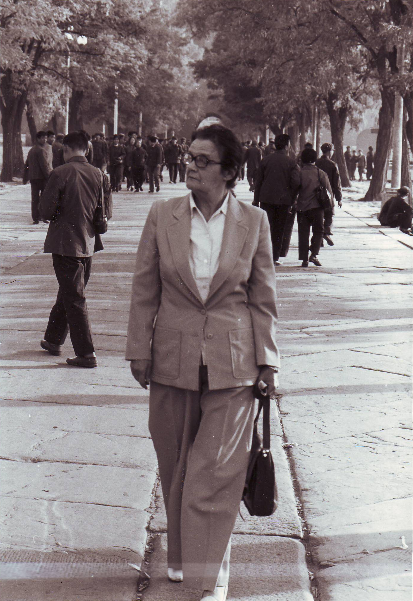 Clare Hollingworth strolls on a street in Beijing in the 1970s/80s.