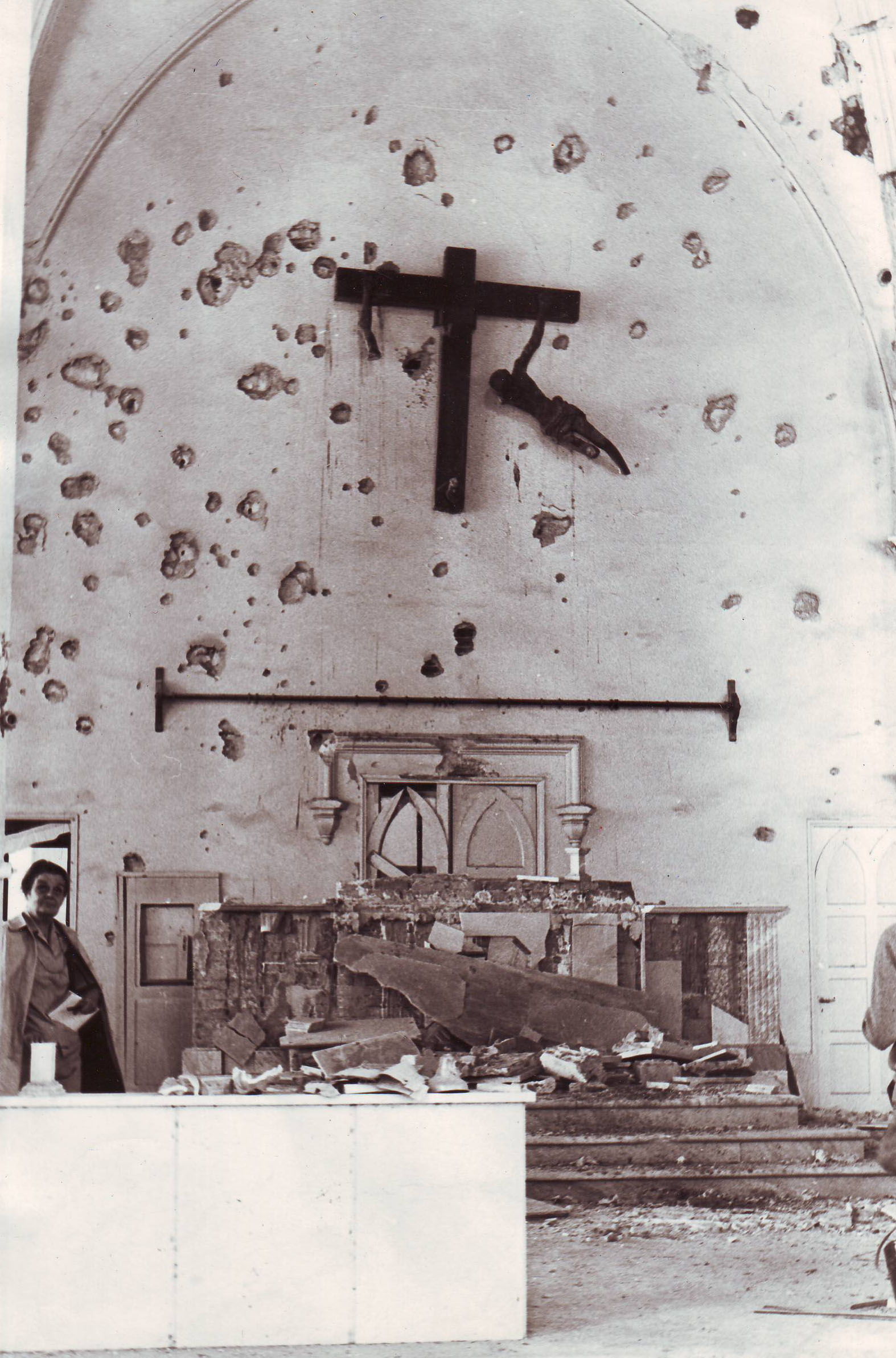 Clare looks into a battered church, likely during Bangladesh's war for independence in the early 1970s.