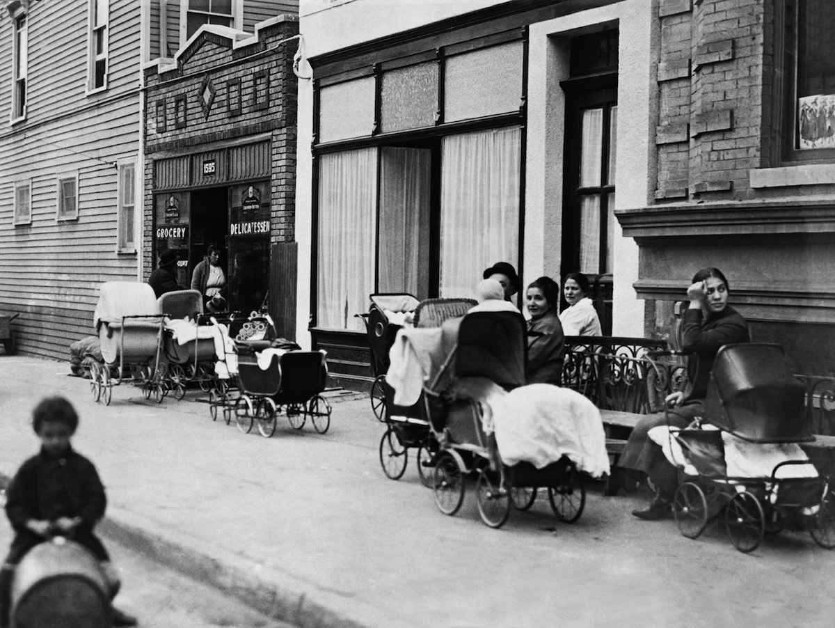 Women and men sitting with baby carriages in front of the Sanger Clinic in Brooklyn, N.Y., October 1916. (Underwood Archives / Getty Images)