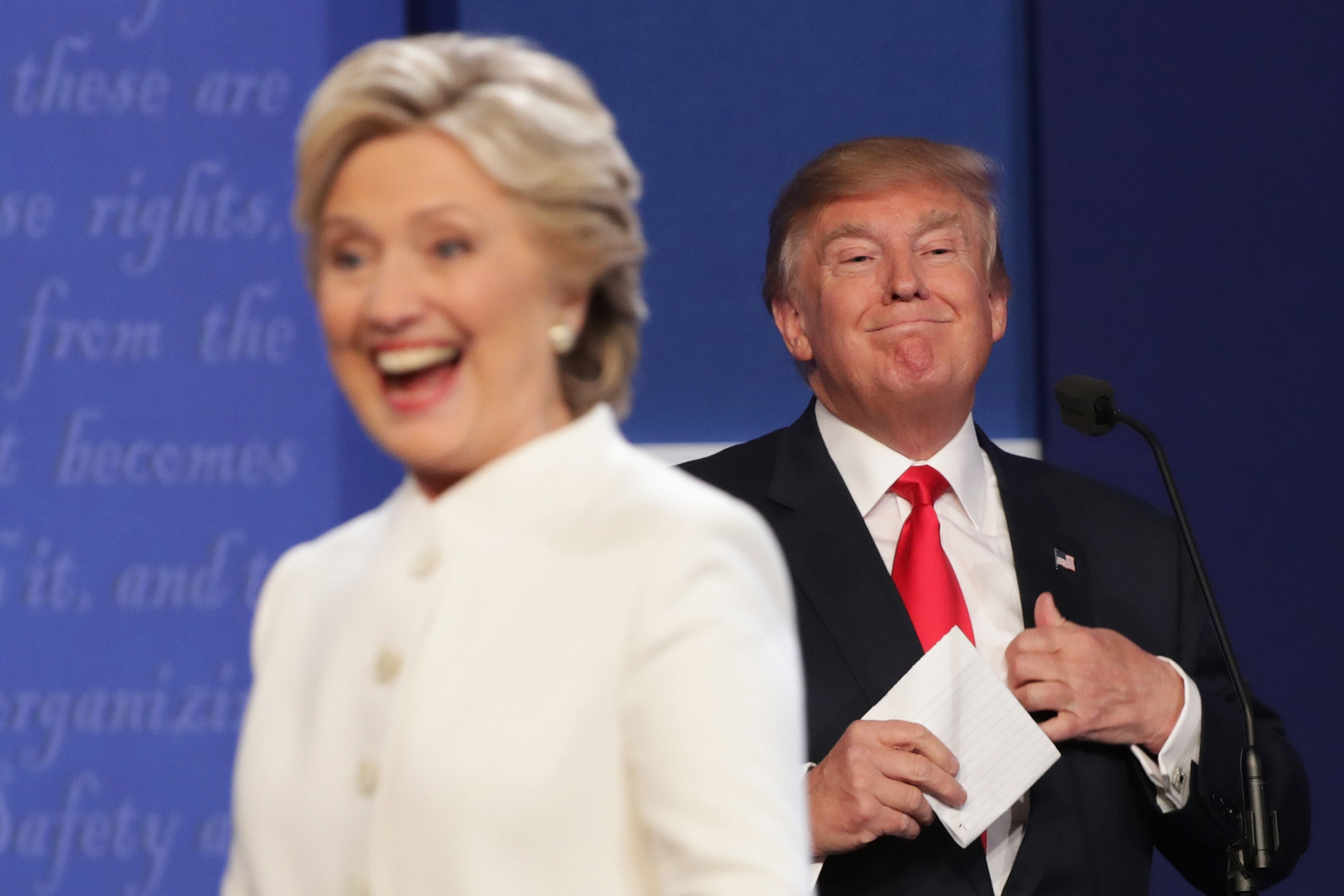 Hillary Clinton walks off stage as Donald Trump smiles after the third U.S. presidential debate in Las Vegas, on Oct. 19, 2016. (Chip Somodevilla—Getty Images)