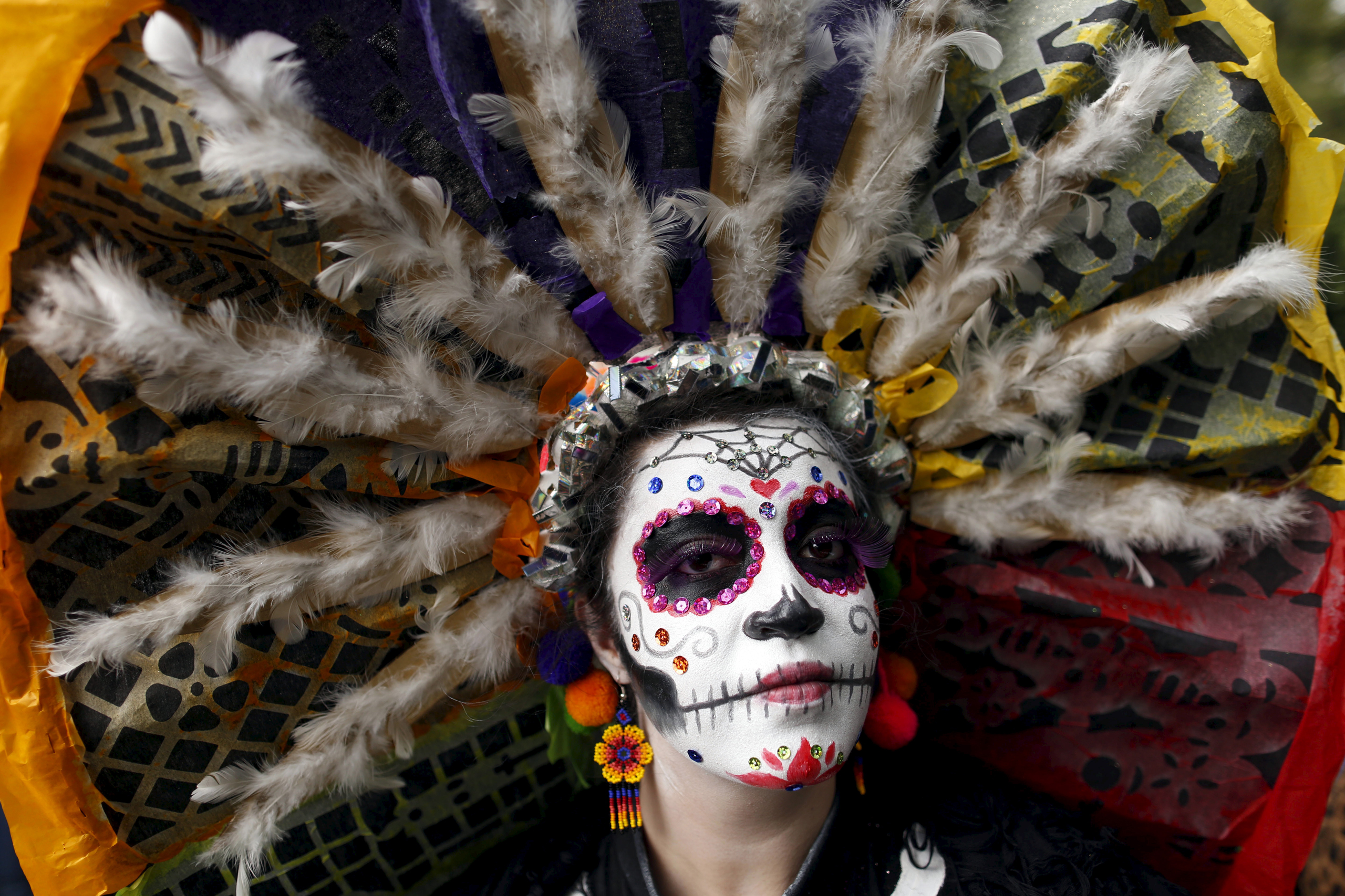 A woman with her face painted to look like the popular Mexican figure called "Catrina", poses for a photograph as she takes part in the annual Catrina Fest in Mexico City on Nov. 1, 2015. (Carlos Jasso—Reuters)