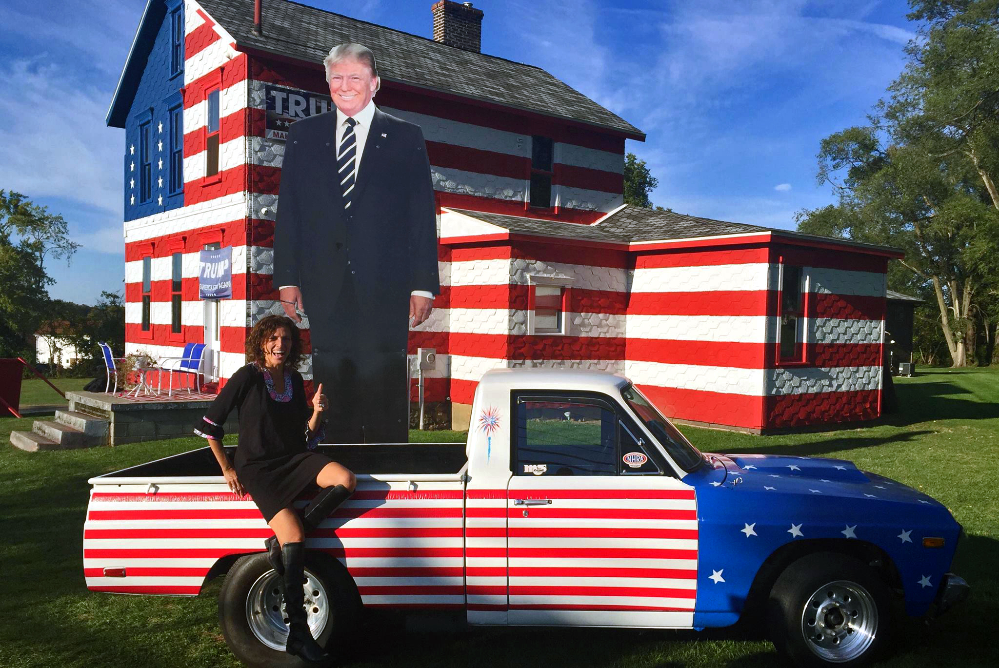 Leslie Rossi sits outside of her "Trump House" in Latrobe, Pennsylvania. She said thousands of people check out the house every week.