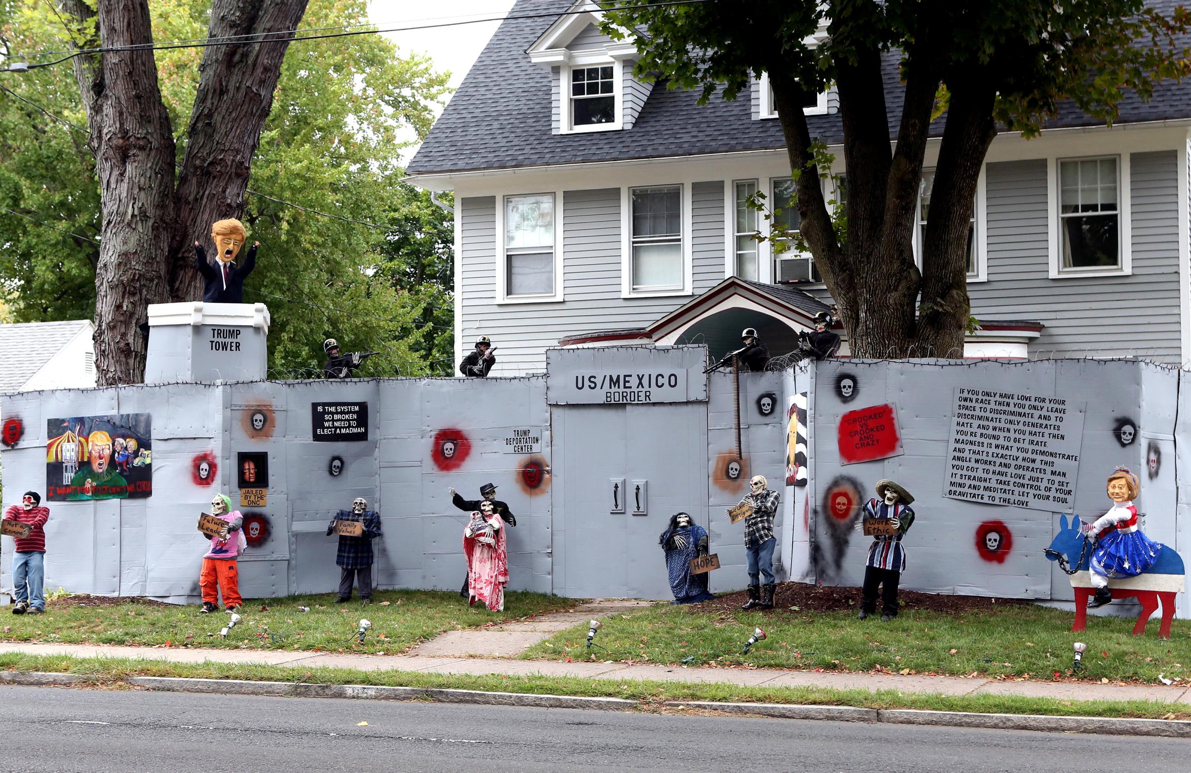 A display features a "border wall" and figures in the likeness of Donald Trump, Hillary Clinton and Bernie Sanders on the property of Matt Warshauer in West Hartford, Conn. on Oct. 4, 2016.