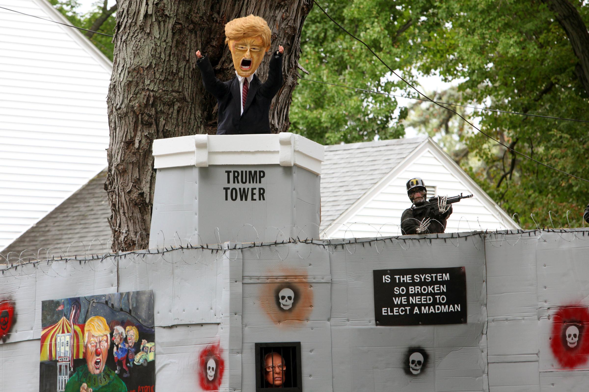 A Halloween display featuring a border wall and figures of Donald Trump, Hillary Clinton and Bernie Sanders is seen on the property of Matt Warshauer in West Hartford