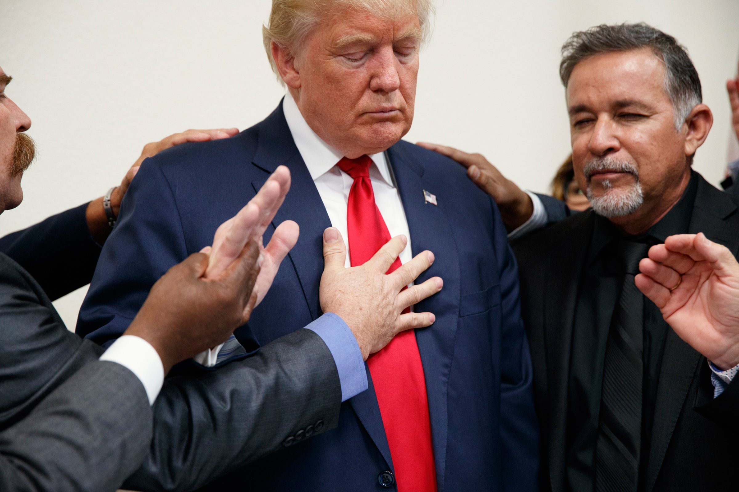 Pastors from the Las Vegas area pray with Republican presidential candidate Donald Trump during a visit to the International Church of Las Vegas, and International Christian Academy, Wednesday, Oct. 5, 2016, in Las Vegas. (AP Photo/ Evan Vucci)