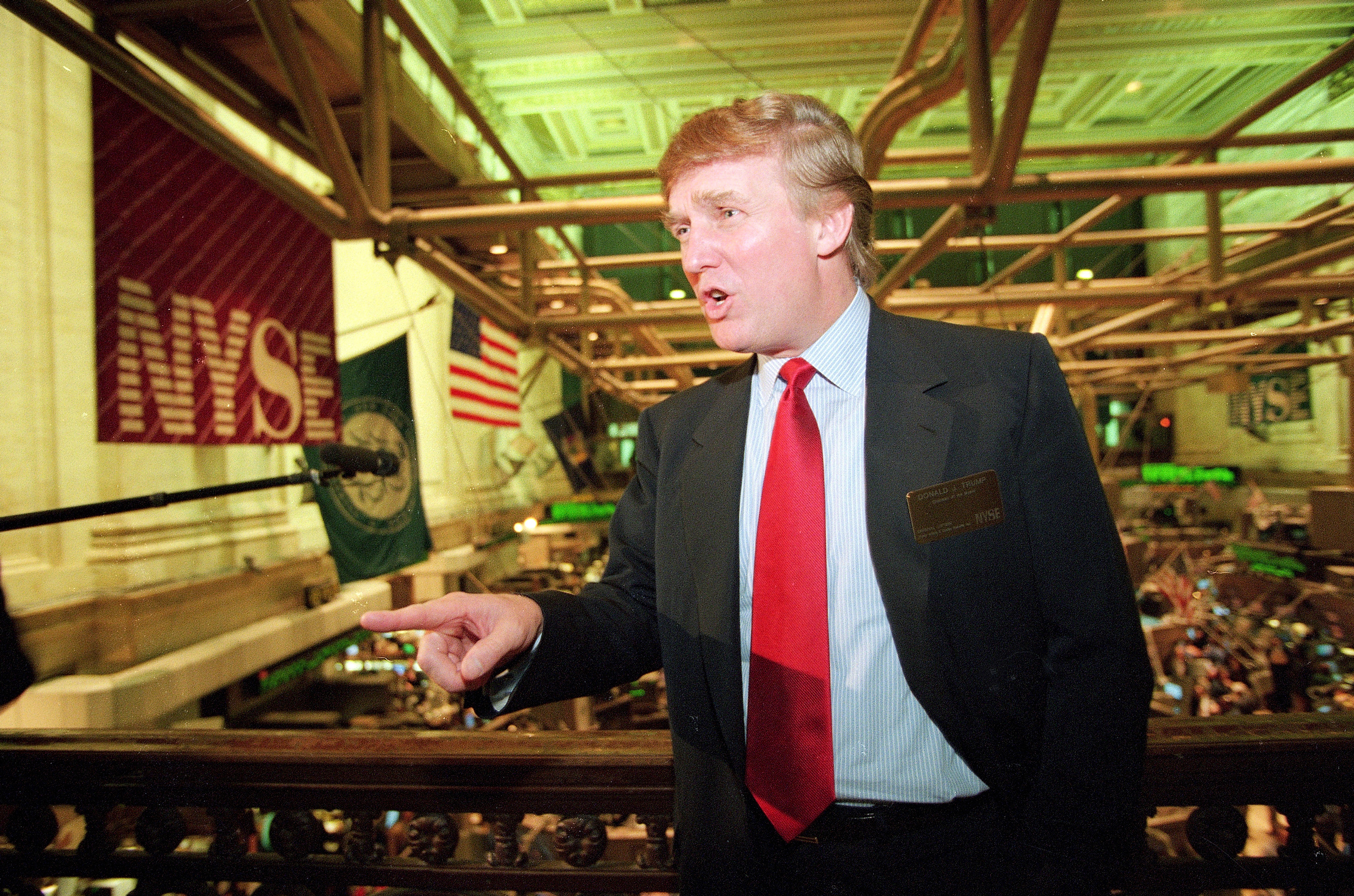 Donald Trump posing for photos above the floor of the New York Stock Exchange after taking his flagship Trump Plaza Casino public in New York City on June 7, 1995. Trump's business losses in 1995 were so large that they could have allowed him to avoid paying federal income taxes for as many as 18 years, according to records obtained by The New York Times. (Kathy Willens—AP)