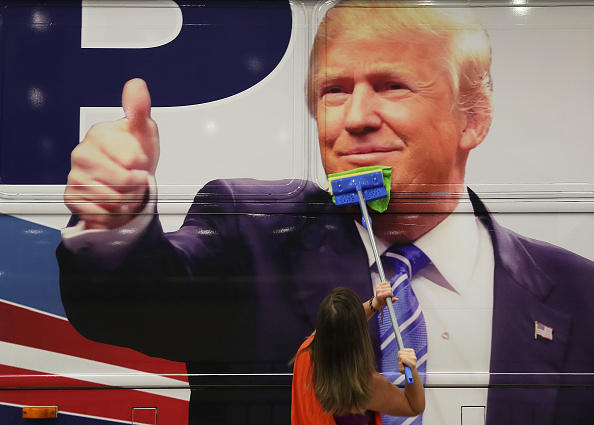 Bailey McDaniel wipes off the side of the campaign bus of Republican presidential candidate Donald Trump before his campaign rally at the South Florida Fair Expo Center on October 13, 2016 in West Palm Beach, Florida. (Joe Raedle—Getty Images)