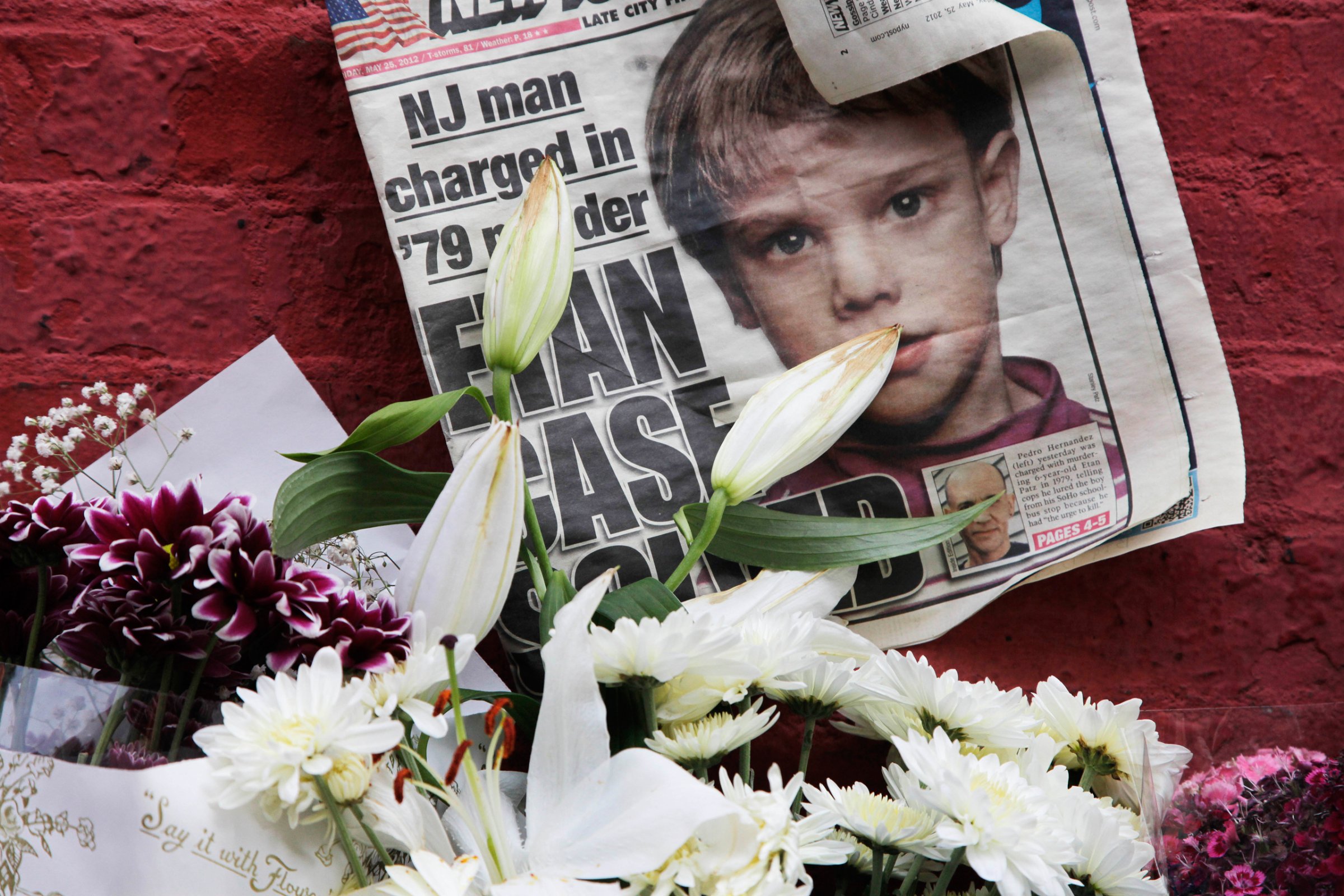 A newspaper with a photograph of Etan Patz is part of a makeshift memorial in the SoHo neighborhood of New York, Monday, May 28, 2012. For prosecutors, the work is just beginning after the astonishing arrest last week of a man who police say confessed to strangling the 6-year-old New York City boy 33 years ago in one of the nation's most bewildering missing children's cases. Pedro Hernandez, 51, was charged with second-degree murder in the 1979 death of Etan Patz, based largely on a signed confession he gave to detectives. (AP Photo/Mark Lennihan)