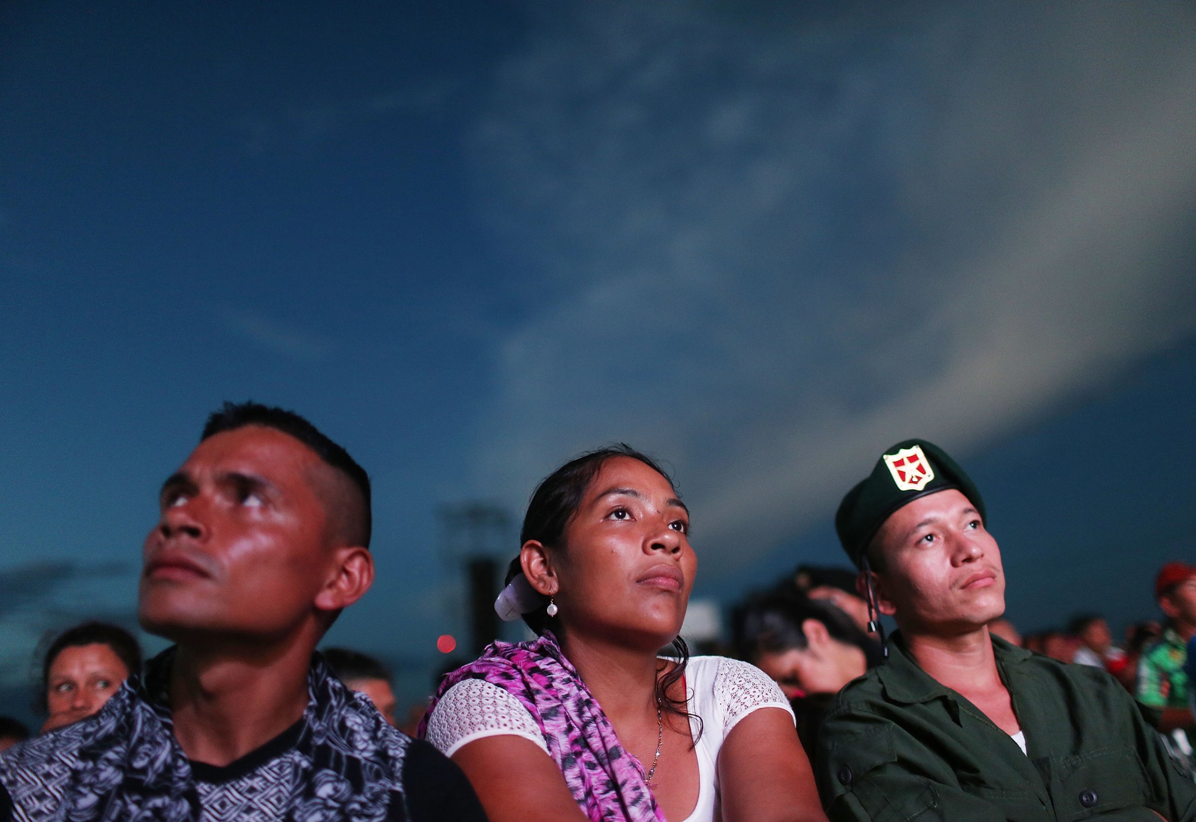 Revolutionary Armed Forces of Colombia (FARC) rebels watch a live broadcast of the peace agreement ceremony while at a FARC encampment in the remote Yari plains where the peace accord was ratified by the FARC on September 26, 2016 in El Diamante, Colombia. The peace agreement attempts to end the 52-year-old guerrilla war between the FARC and the state, the longest-running armed conflict in the Americas which has left 220,000 dead. The final agreement will be put to vote by the public in a referendum on October 2. The plan calls for a disarmament and re-integration of most of the estimated 7,000 FARC fighters. (Photo by Mario Tama/Getty Images)