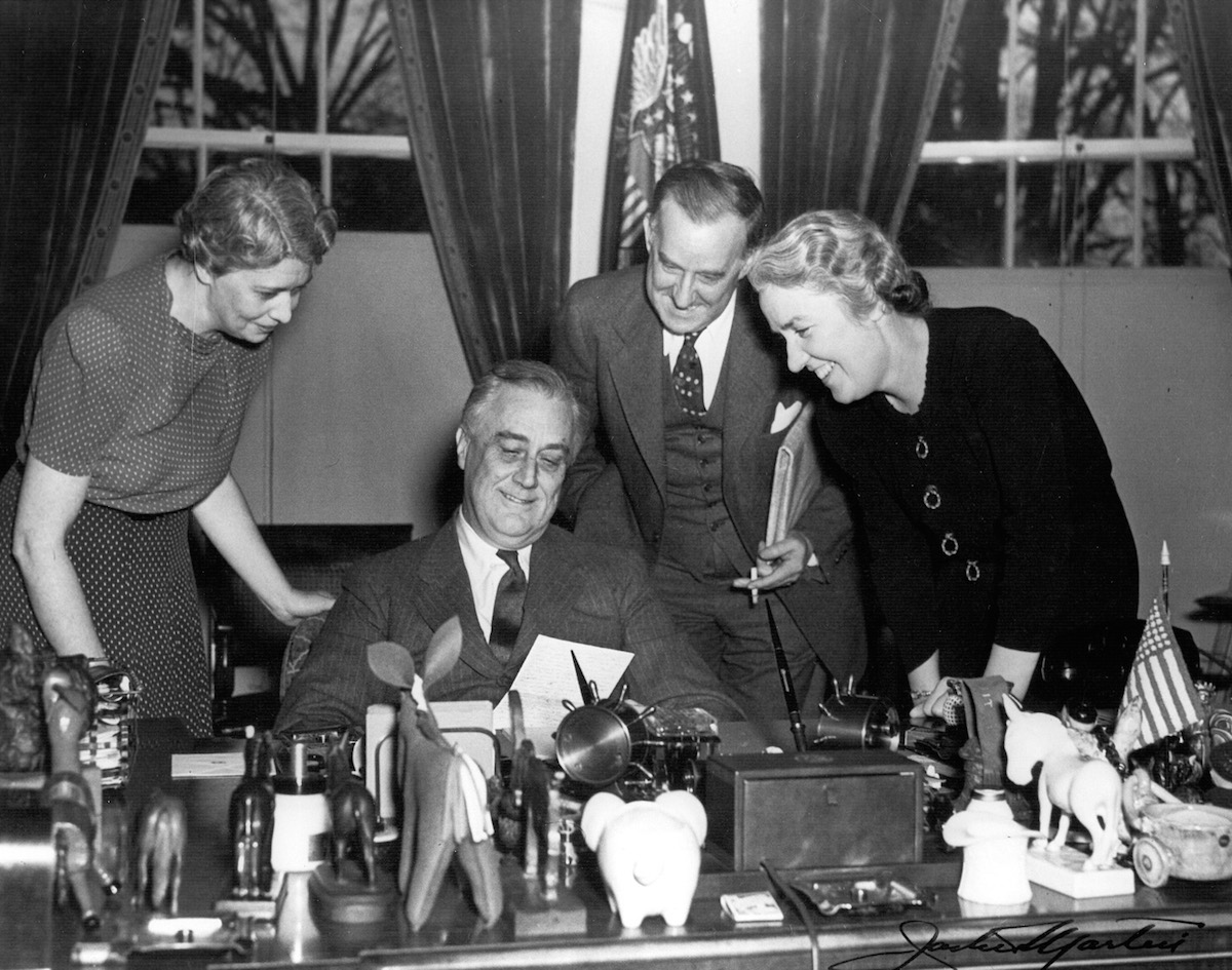 President Roosevelt at his desk in the White House with (left to right) Marguerite LeHand, Stephen Early, and Grace Tully, May 22, 1941. (FDR Library Collection / Getty Images)