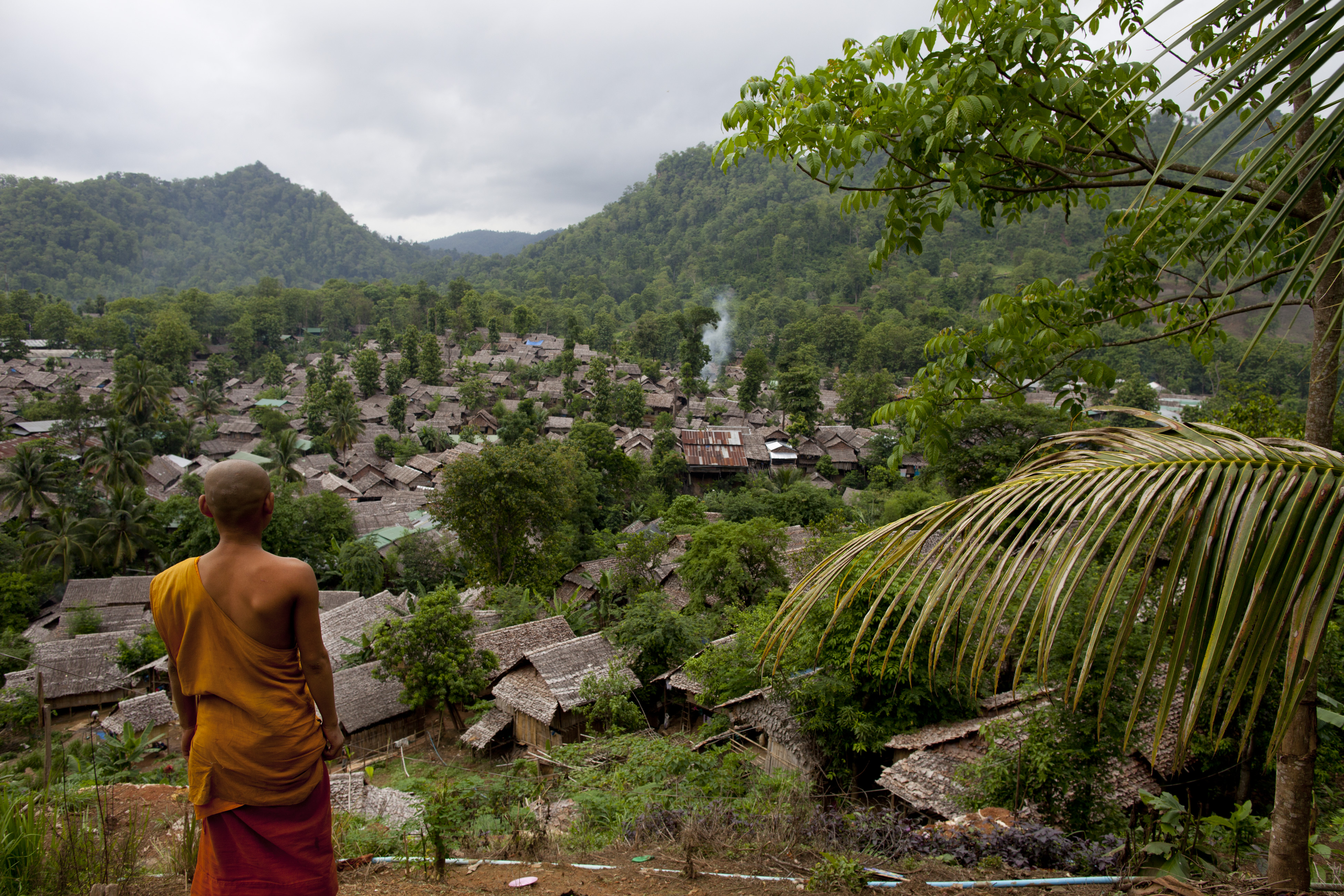A Burmese monk looks out from a viewpoint at the Mae La refugee camp in Tak province, Thailand, on June 6, 2012 (Paula Bronstein—Getty Images)