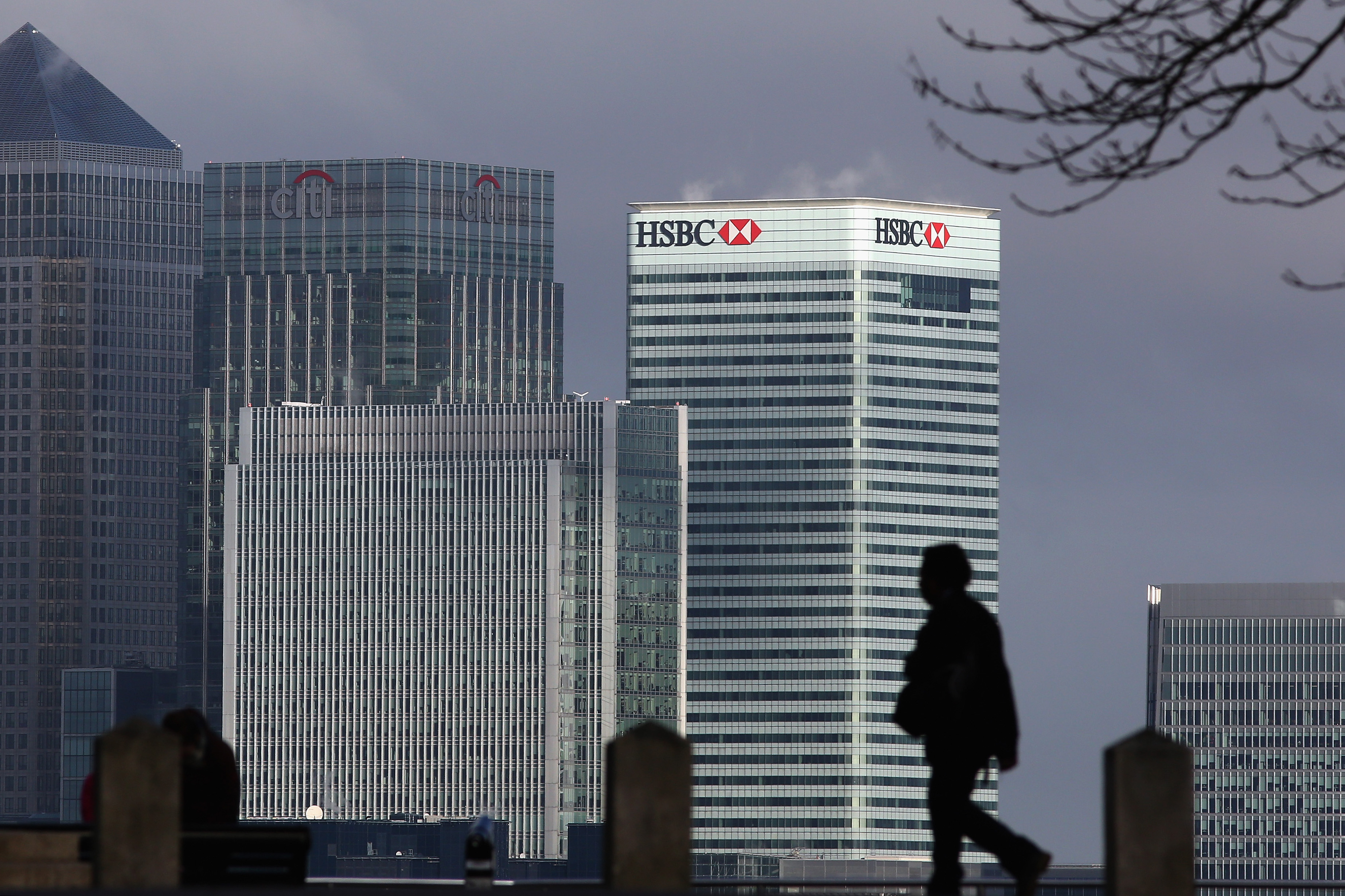 A man is silhouetted against The HSBC Holdings Plc headquarters in the Canary Wharf business, financial and shopping district on Feb.15, 2016 in London, England. (Dan Kitwood—Getty Images)