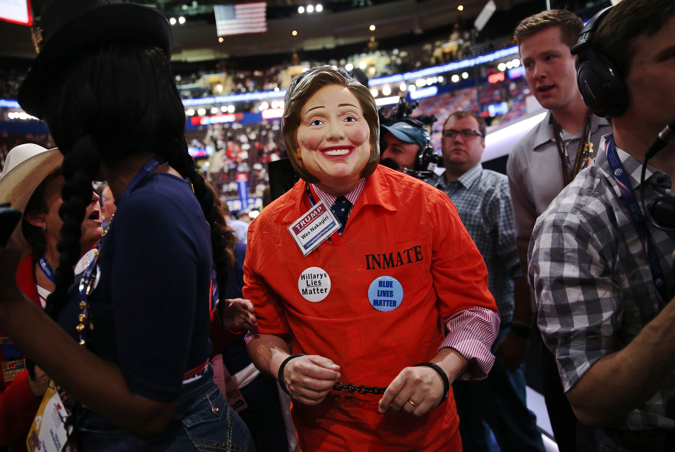 An attendee wears an inmate costume and mask in the likeness of Hillary Clinton during the Republican National Convention (RNC) in Cleveland  on July 21, 2016.