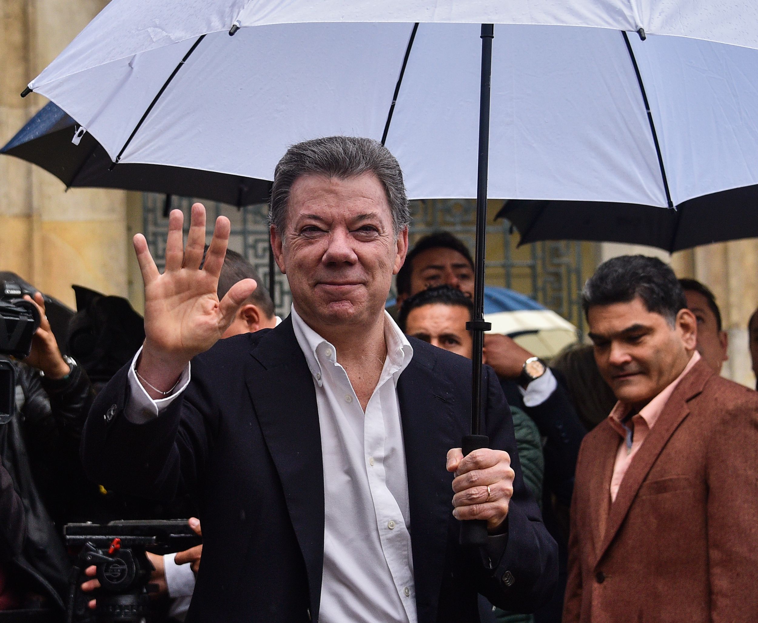 Colombian President Juan Manuel Santos waves after casting his vote during a referendum on whether to ratify a historic peace accord to end a 52-year war between the state and the communist FARC rebels, in Bogota on October 2, 2016. (GUILLERMO LEGARIA—AFP/Getty Images)