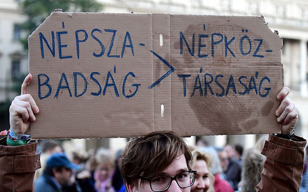 A young man holds up a poster reading "Nepszabadsag &gt; People's Republic Company" as journalist of Hungary's biggest opposition newspaper Nepszabadsag and their supporters protest in front of the parliament building in Budapest on October 8, 2016.
                      The newspaper suspended its activities, heightening concerns about media plurality under right-wing Prime Minister Viktor Orban. / AFP / ATTILA KISBENEDEK        (Photo credit should read ATTILA KISBENEDEK/AFP/Getty Images) (ATTILA KISBENEDEK&mdash;AFP/Getty Images)