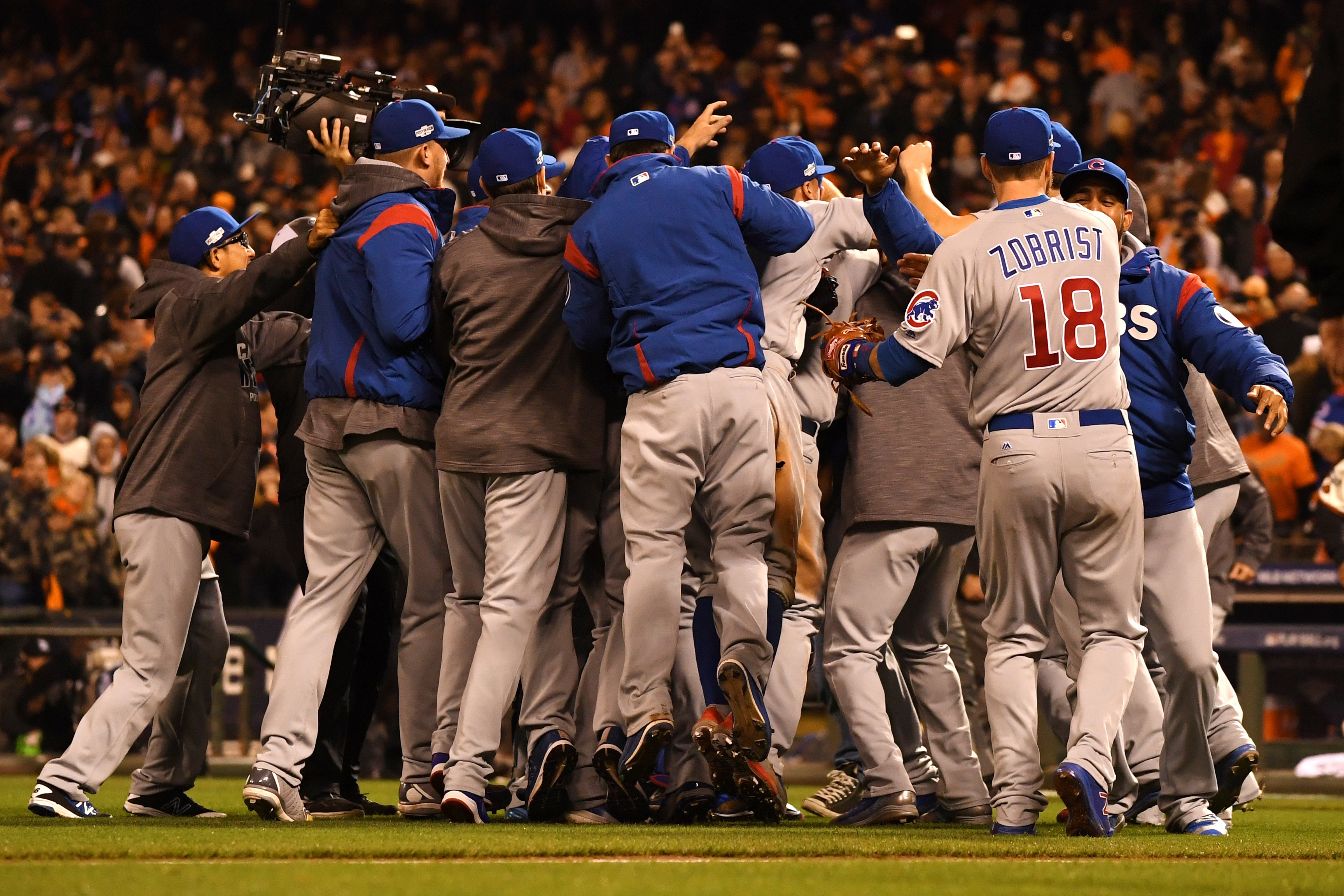 The Chicago Cubs celebrate after defeating the San Francisco Giants 6-5 in Game Four of their National League Division Series to advance to the National League Championship Series. (Thearon W. Henderson&mdash;Getty Images)