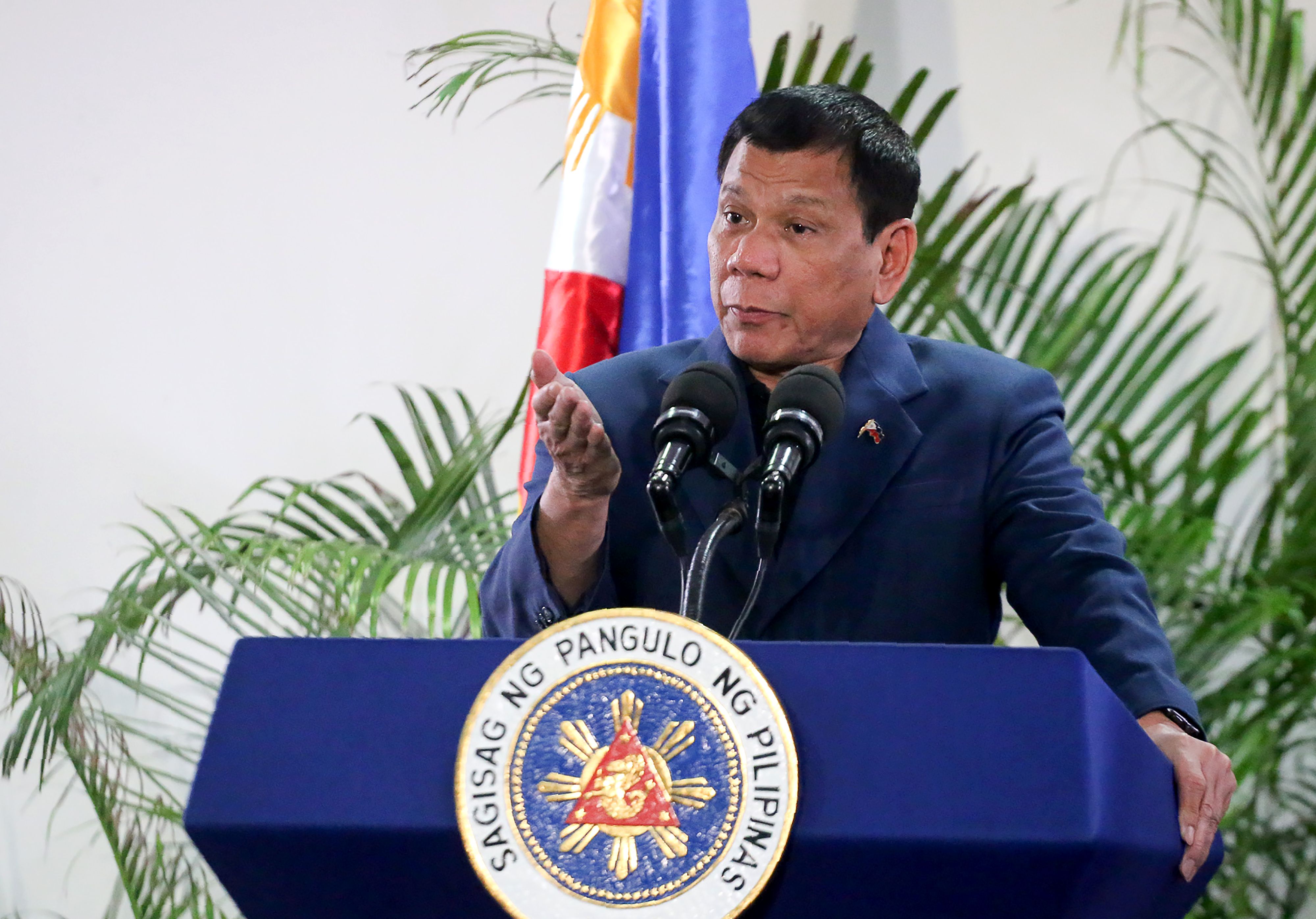 Philippine President Rodrigo Duterte speaks at the Davao International Airport in the Philippine city of Davao after returning from a state visit to Brunei and China on Oct. 22, 2016 (Manman Dejeto—AFP / Getty Images)