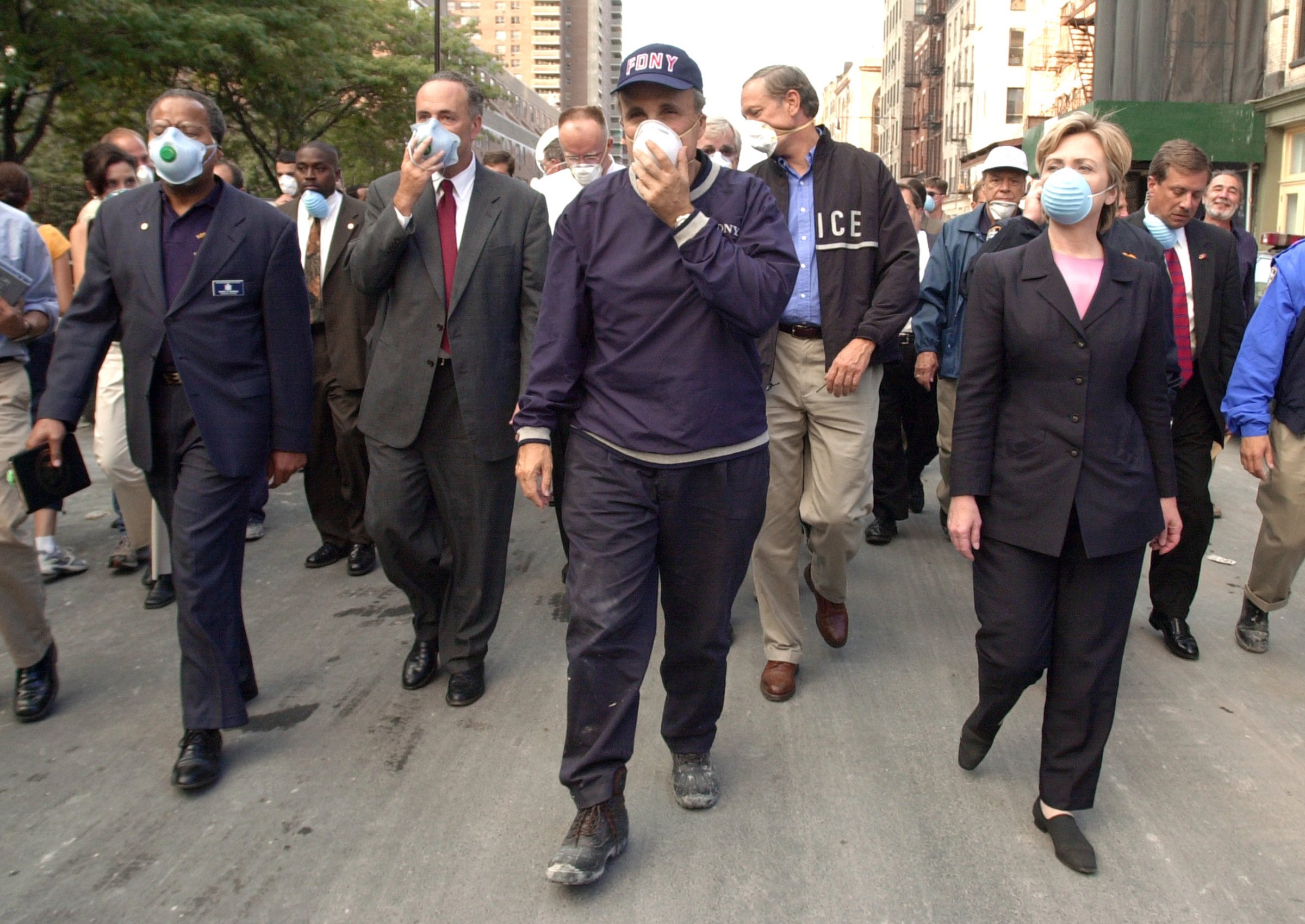 NEW YORK, NY - SEPTEMBER 12: New York City Mayor Rudolph Giuliani (C) leads US Senator Charles Schumer, R-NY (2nd L), New York Governor George Pataki (2nd R) and US Senator Hillary Rodham Clinton, D-NY (R), on a tour of the site of the World Trade Center disaster 12 September 2001 in New York. (Photo credit should read ROBERT F. BUKATY/AFP/Getty Images)