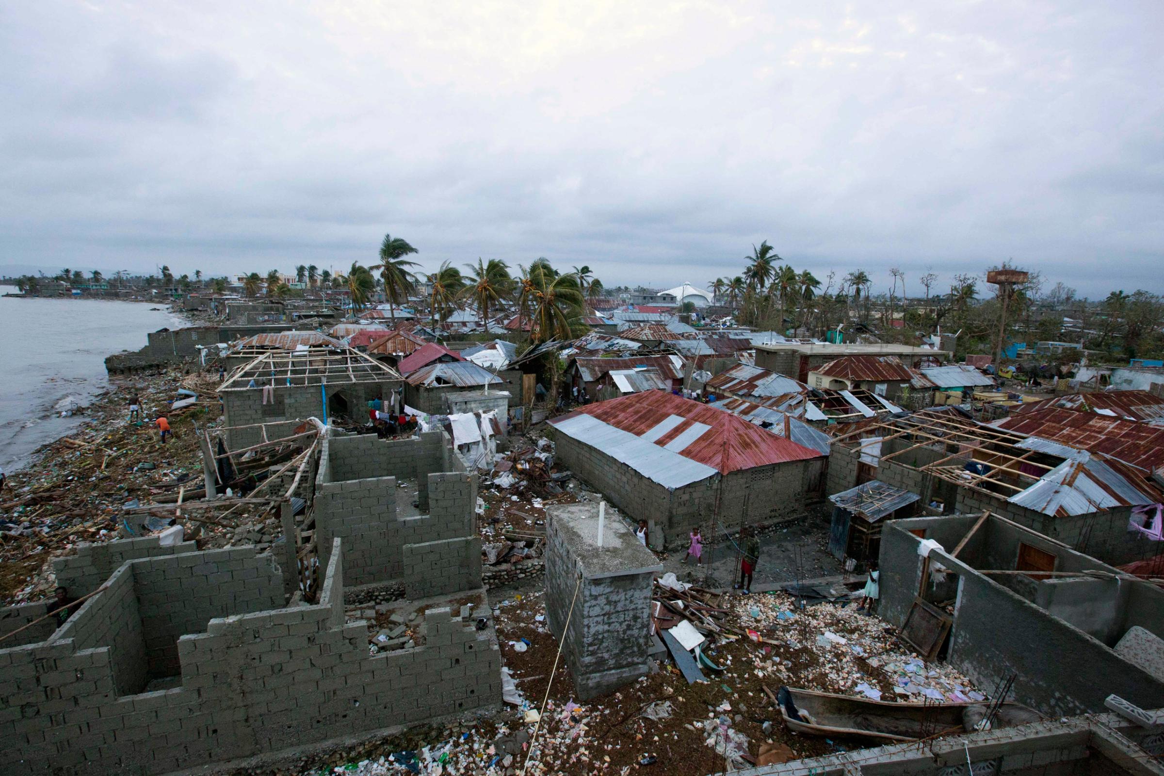Homes lay in ruins after the passing of Hurricane Matthew in Les Cayes, Haiti, Thursday, Oct. 6, 2016. Two days after the storm rampaged across the country's remote southwestern peninsula, authorities and aid workers still lack a clear picture of what they fear is the country's biggest disaster in years. (AP Photo/Dieu Nalio Chery)