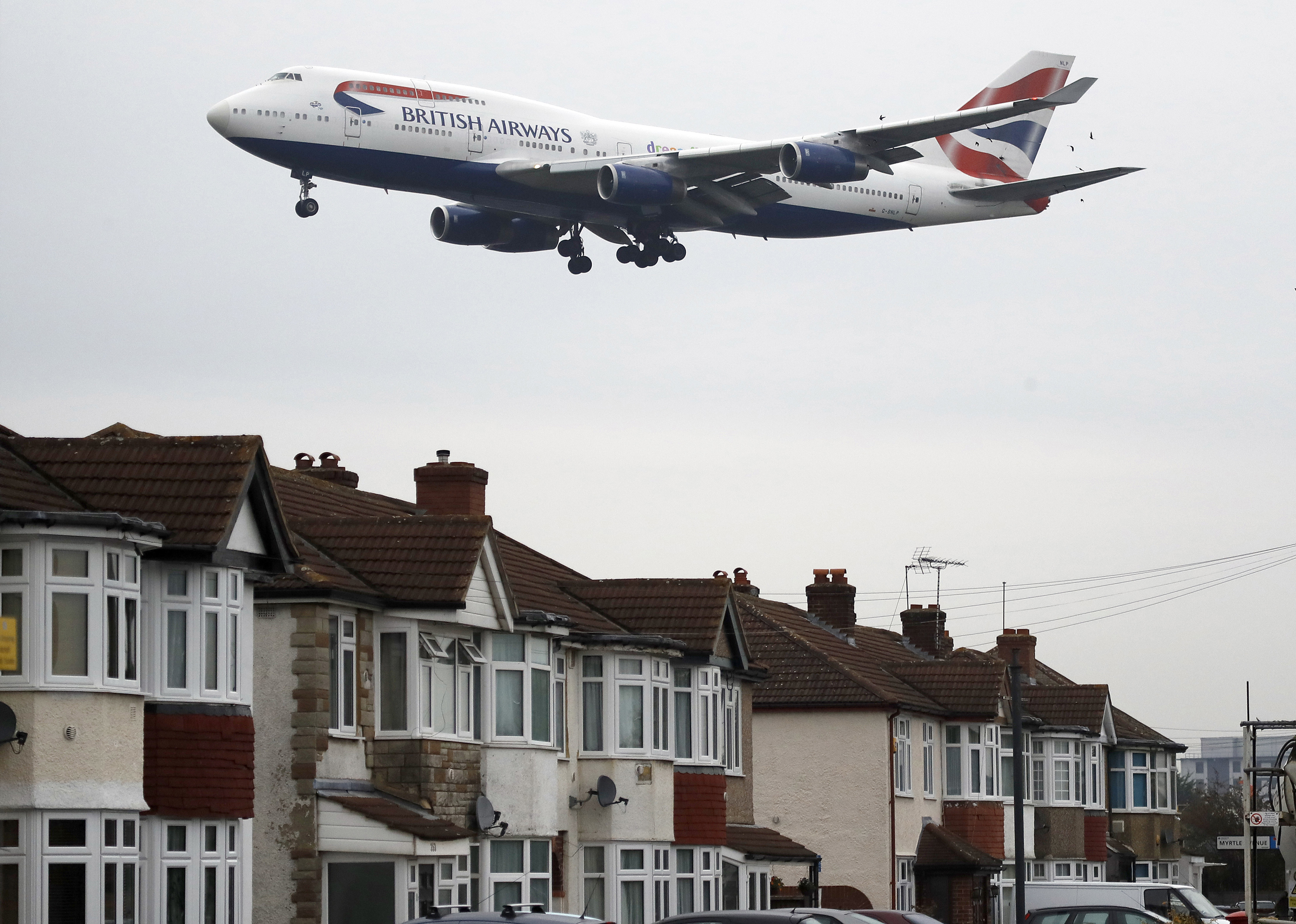 A plane approaches landing over the rooftops of nearby houses at Heathrow Airport in London, on Oct. 25, 2016. (Frank Augstein—AP)