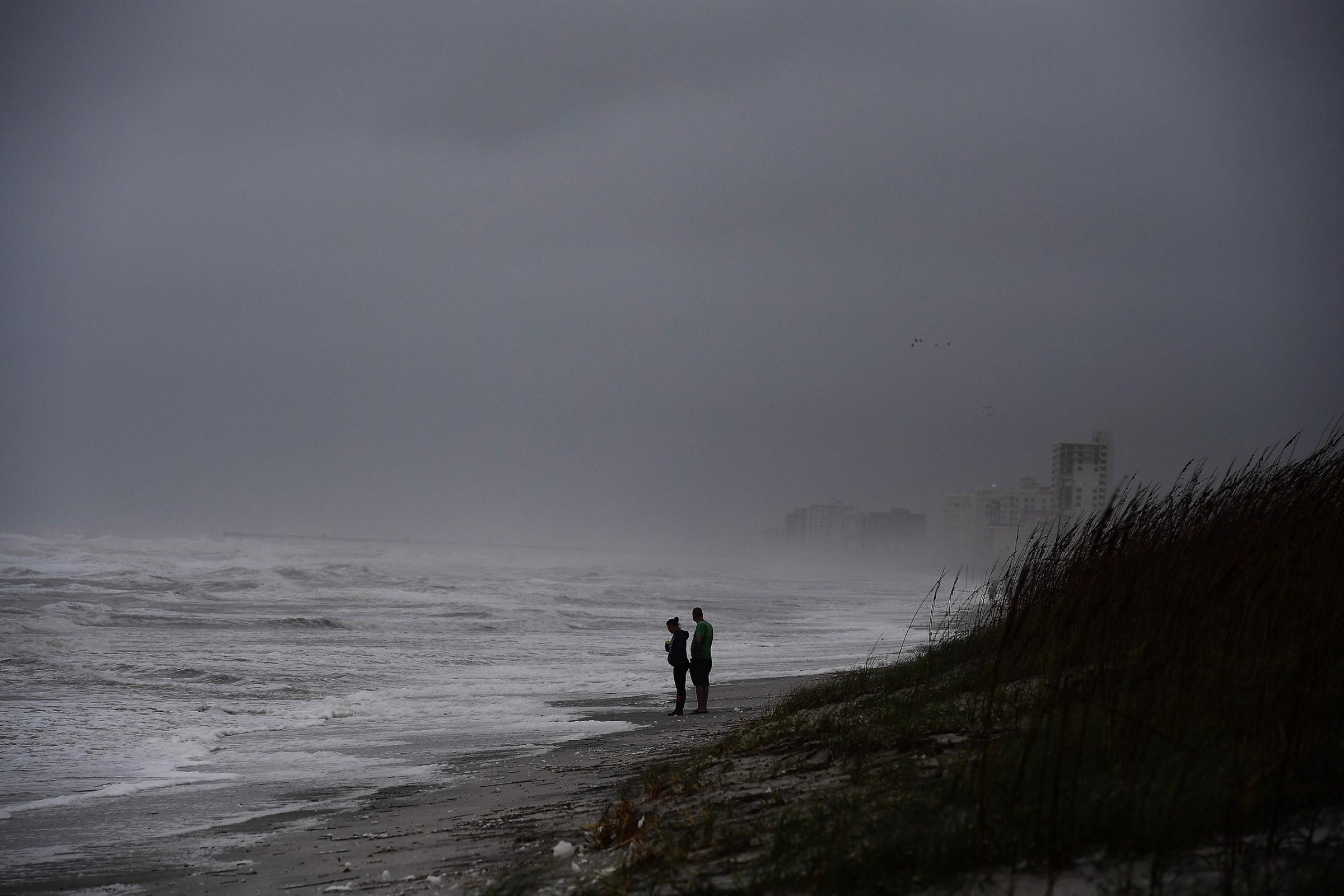 Local residents watch waves at the Atlantic Beach in Jacksonville, Fla., on Oct. 6, 2016.