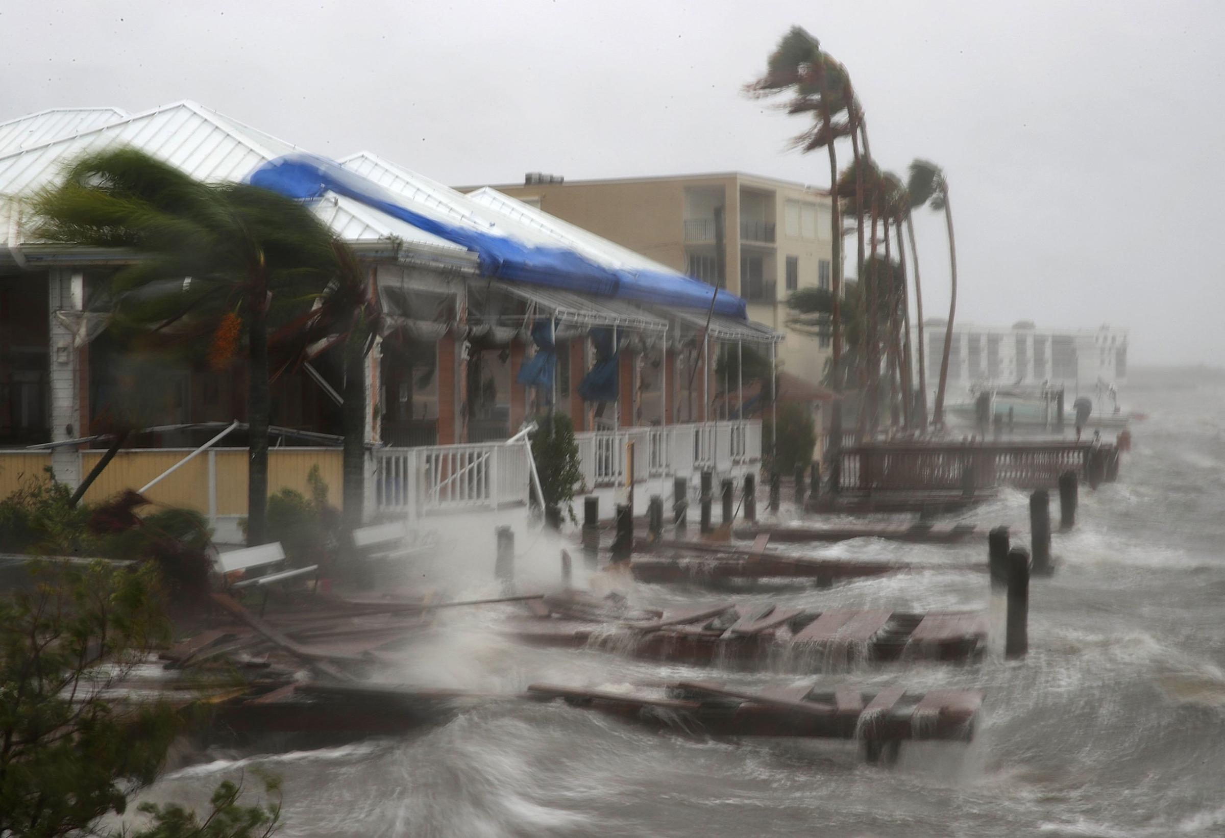 Heavy waves caused by Hurricane Matthew pound the boat docks at the Sunset Bar and Grill on Cocoa Beach, Fla., Oct. 7, 2016.