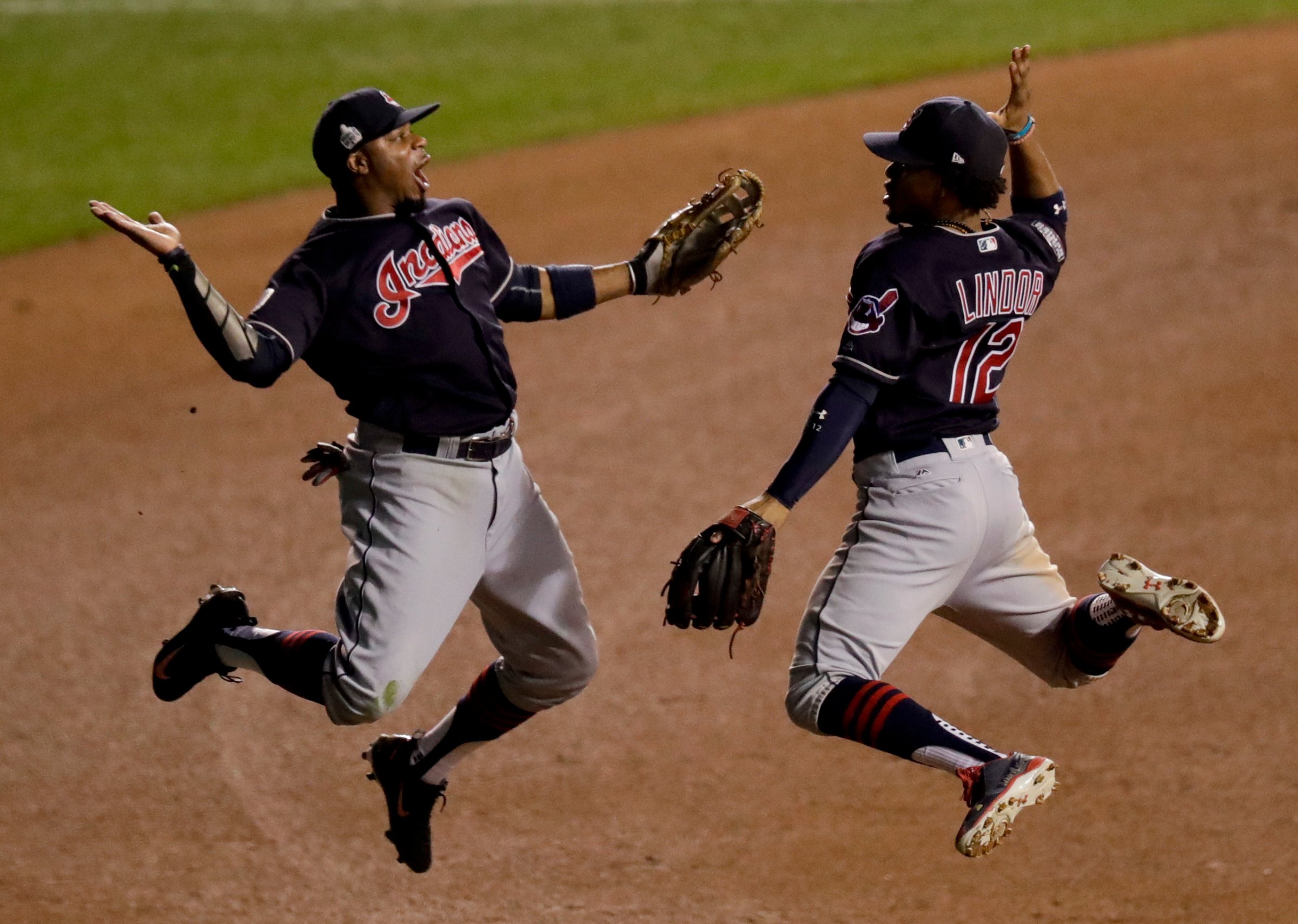 Cleveland Indians left fielder Rajai Davis, left, and shortstop Francisco Lindor celebrate their win after Game 4 of the Major League Baseball World Series against the Chicago Cubs Saturday, Oct. 29, 2016, in Chicago. The Indians won 7-2 to take a 3-1 lead in the series. (AP Photo/Charles Rex Arbogast)