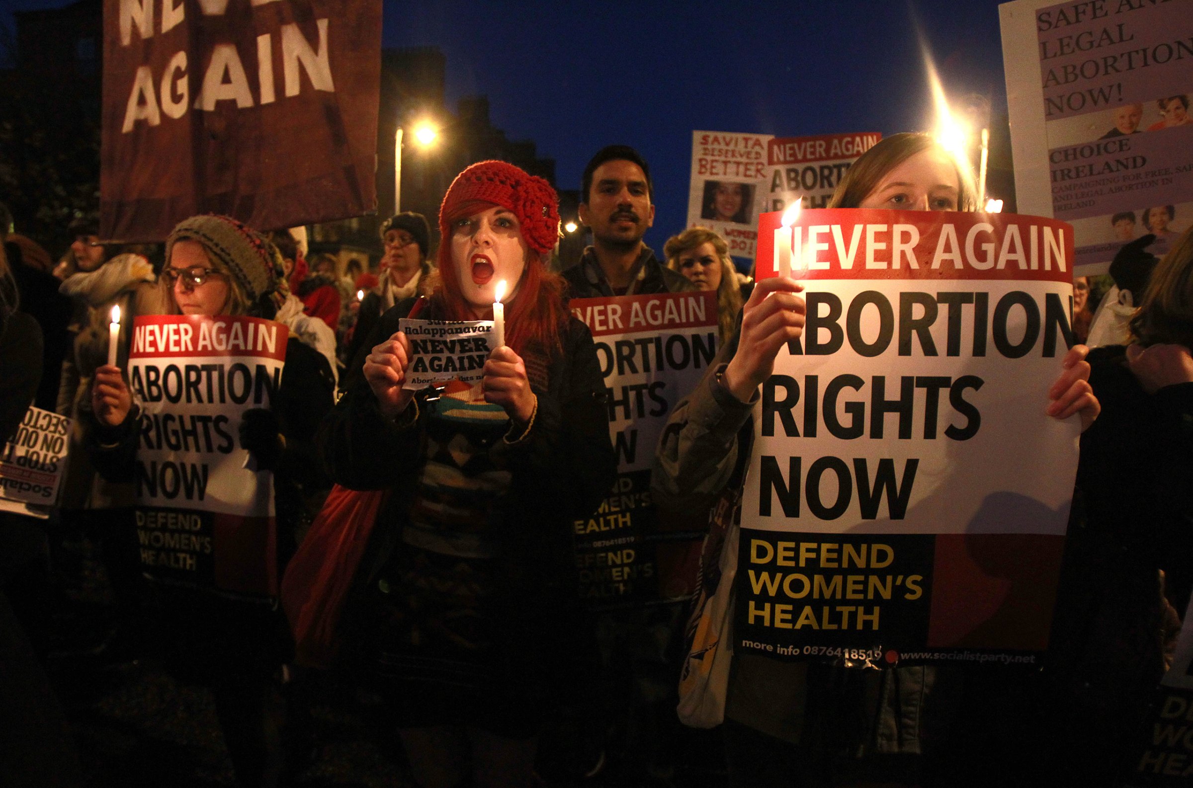 Demonstrators hold placards and candles in memory of Savita Halappanavar, whose doctors allegedly refused to perform an abortion because it was against the laws of the Catholic country, in Dublin on Nov. 17, 2012. The Indian woman, who was 17 weeks pregnant, repeatedly asked the hospital to terminate her pregnancy because she had severe back pain and was miscarrying, her family said.