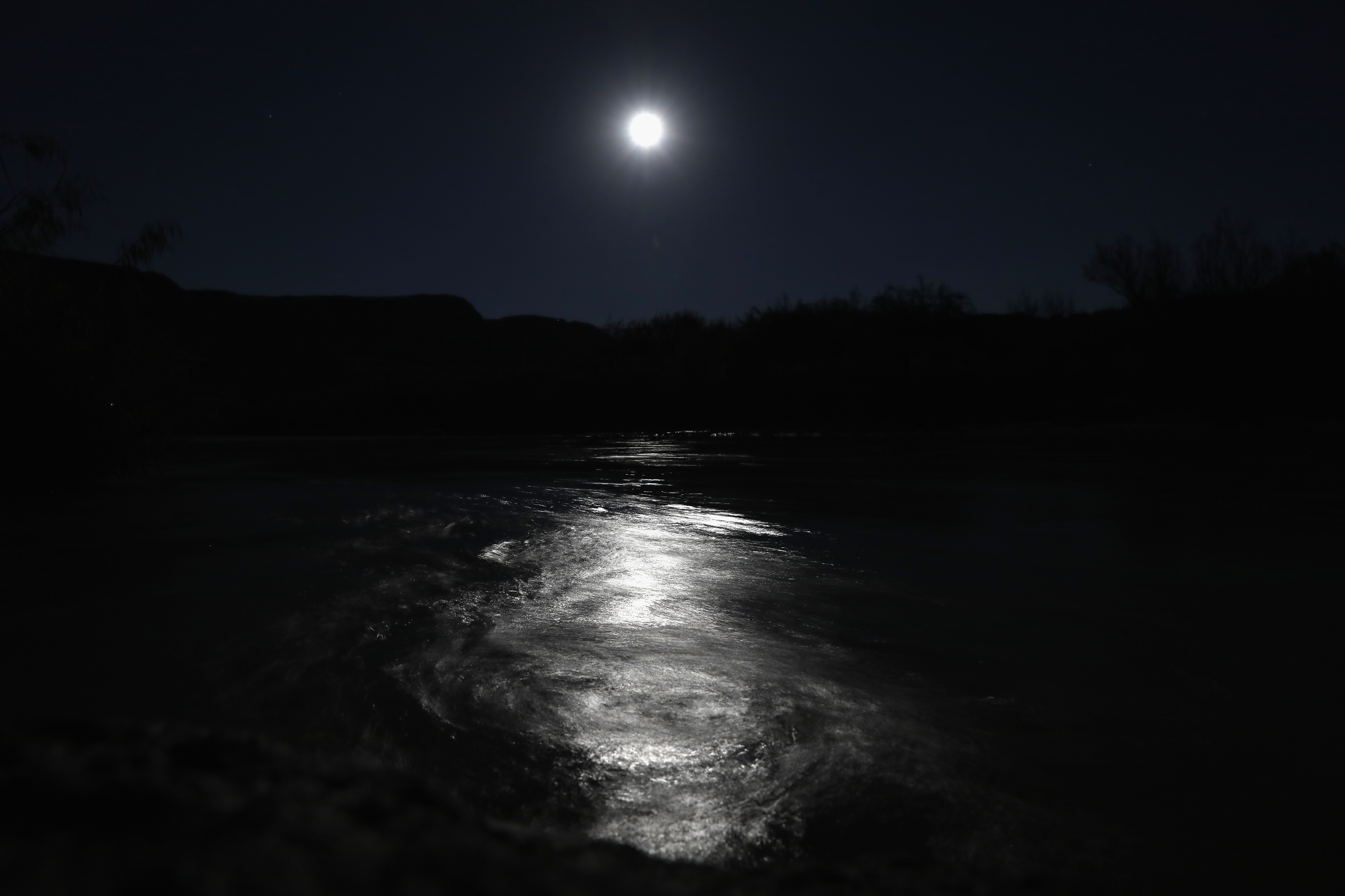 The moon rises over the swirling current of the Rio Grande  on Oct. 15, 2016 in the Big Bend region of West Texas near Lajitas, Texas.