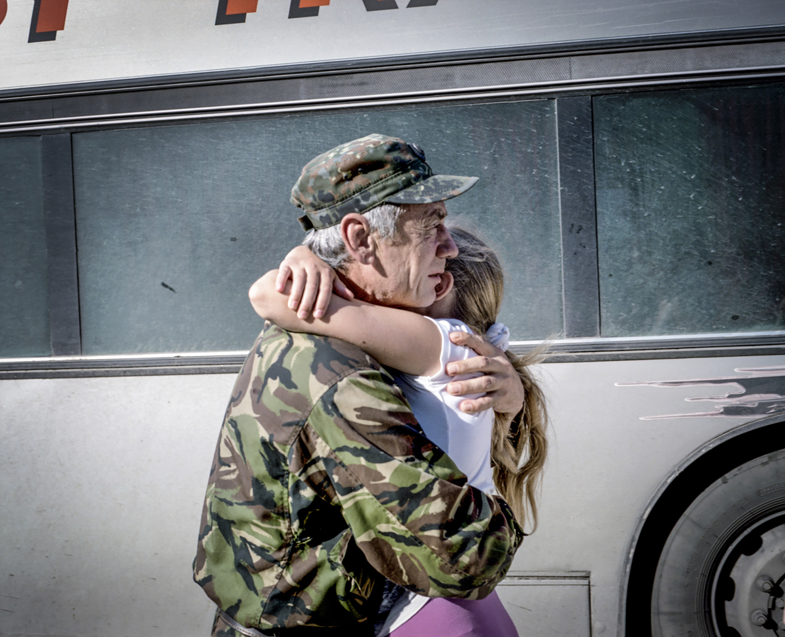 Captain Kasyanenko Nikolay Vasilevich holds his daughter after arriving  from the front line back home, where he was for a year.  Cherkasy, July 2015