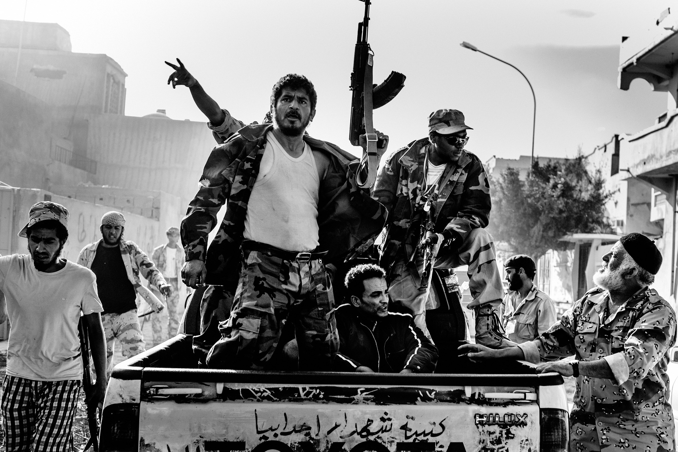 Revolutionary fighters hold hostage a soldier loyal to Libyan leader Moammar Gaddafi, Sirte, Libya, Oct. 20, 2011, the day Gaddafi was killed in Sirte.