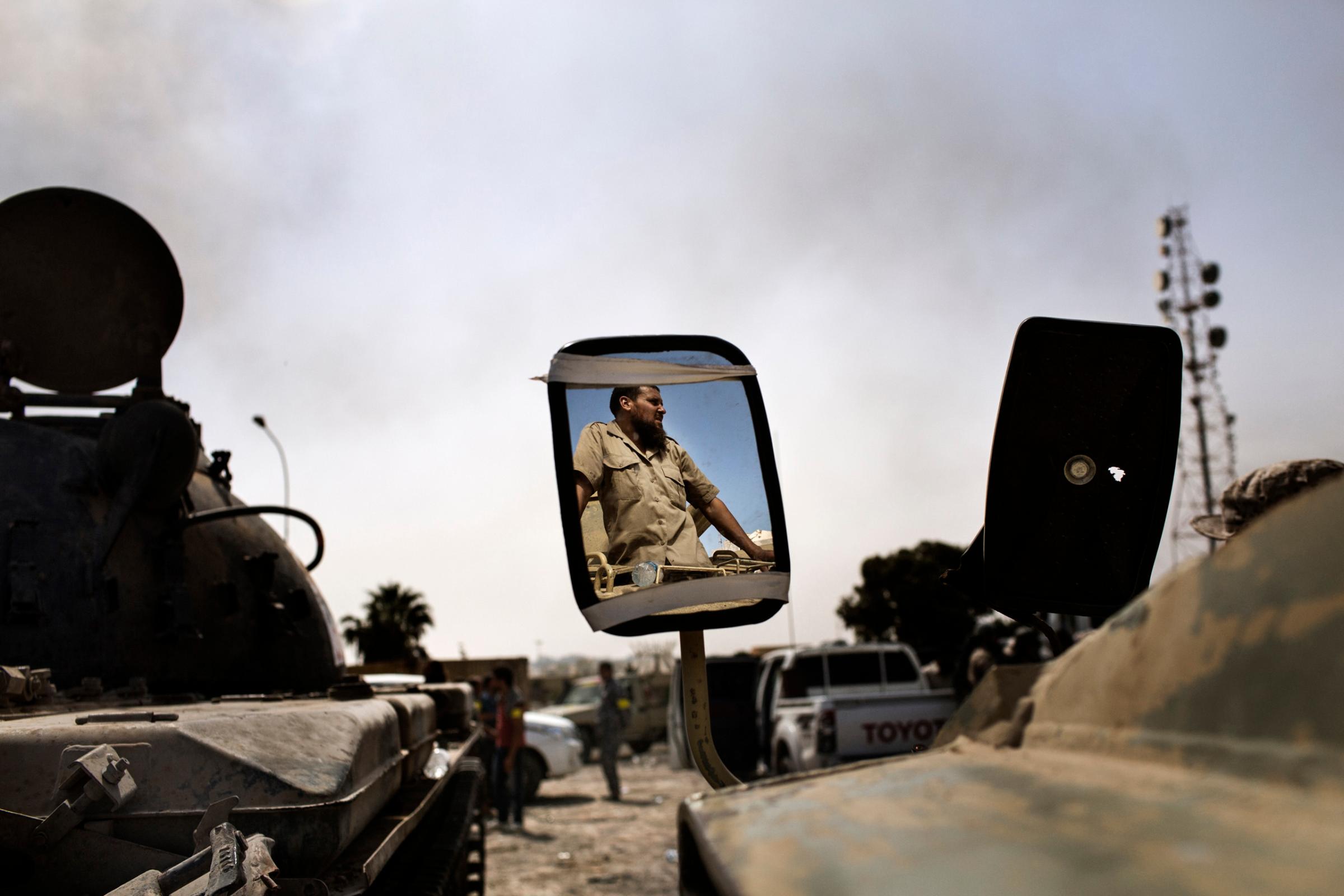 Portrait of a fighter loyal to Libya's Government of National Accord through a Tank's mirrow on the western frontline against IS (Islamic State) in Sirte on October 2, 2016.