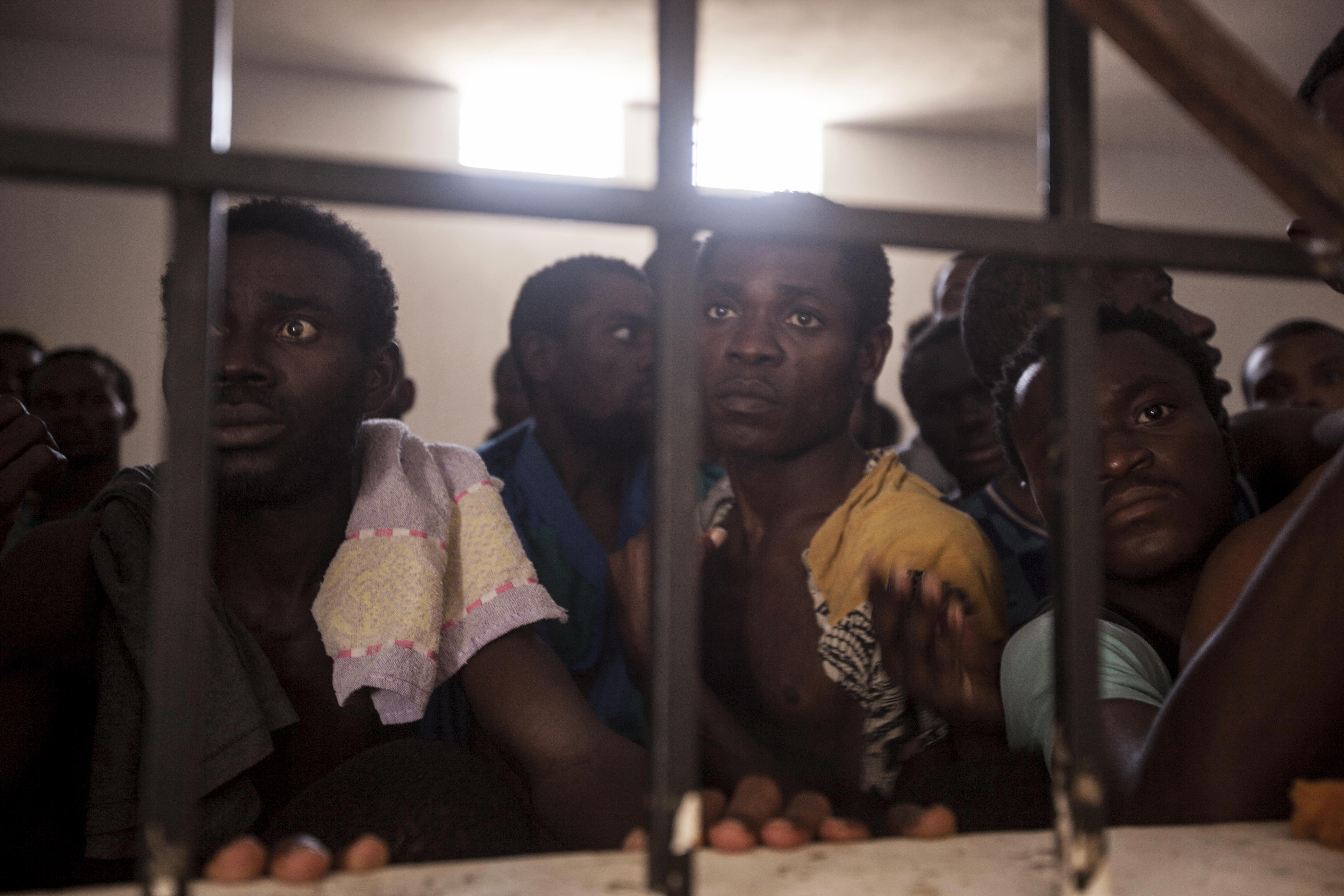 Sub-Saharan migrants and refugees begging for their release in a detention center in Surman, Libya.