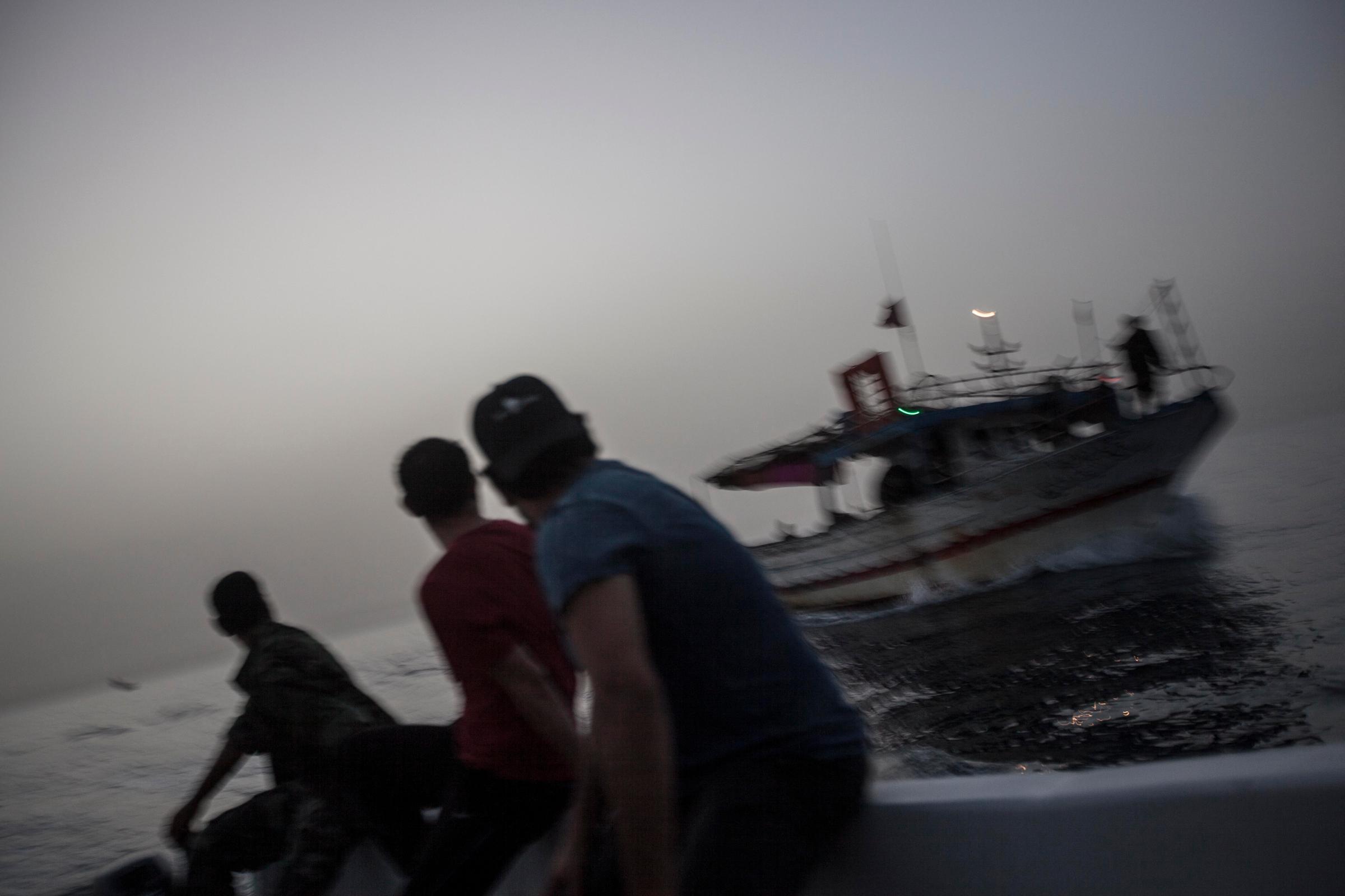 Libyan coastguards escort a boat back to Zawiyah after it was intercepted carrying out illegal activities.