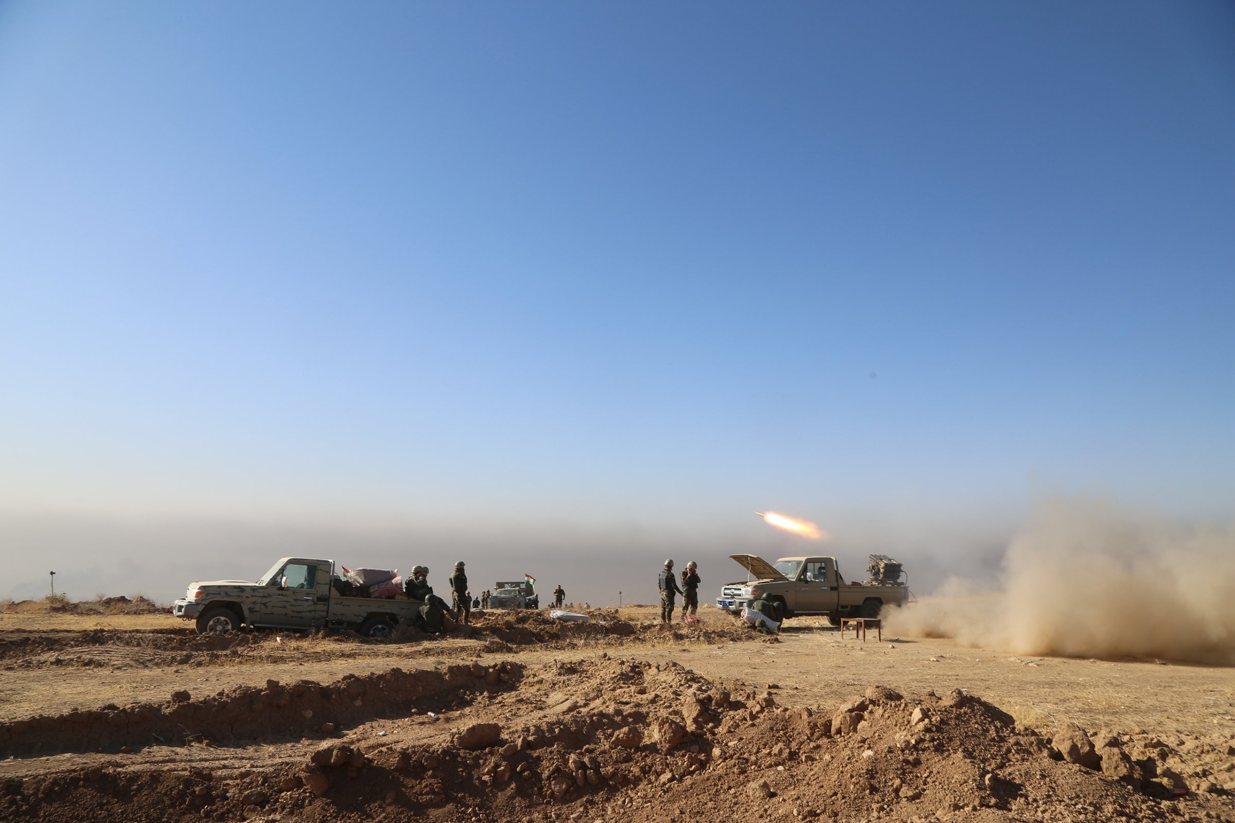 Kurdish Peshmerga forces located at Mount Zardak fire toward an ISIS position during an operation to retake Iraq's Mosul, held by the militant group since 2014, on Oct. 17, 2016.