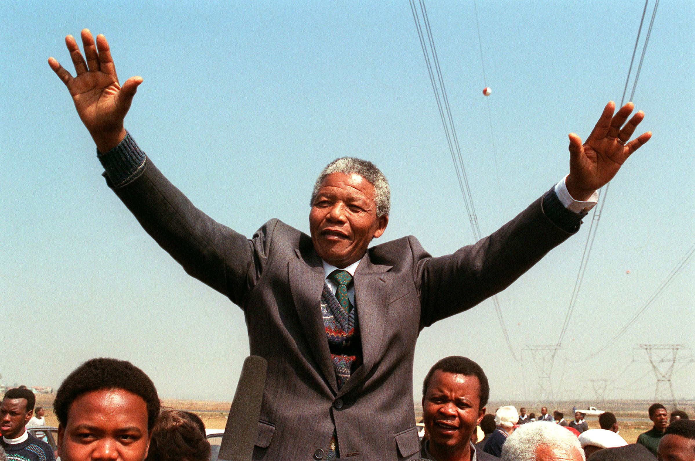 South African National Congress President Nelson Mandela addresses a crowd of residents from the Phola park squatter camp in Tokoza during his tour of townships. Sept. 5, 1990.