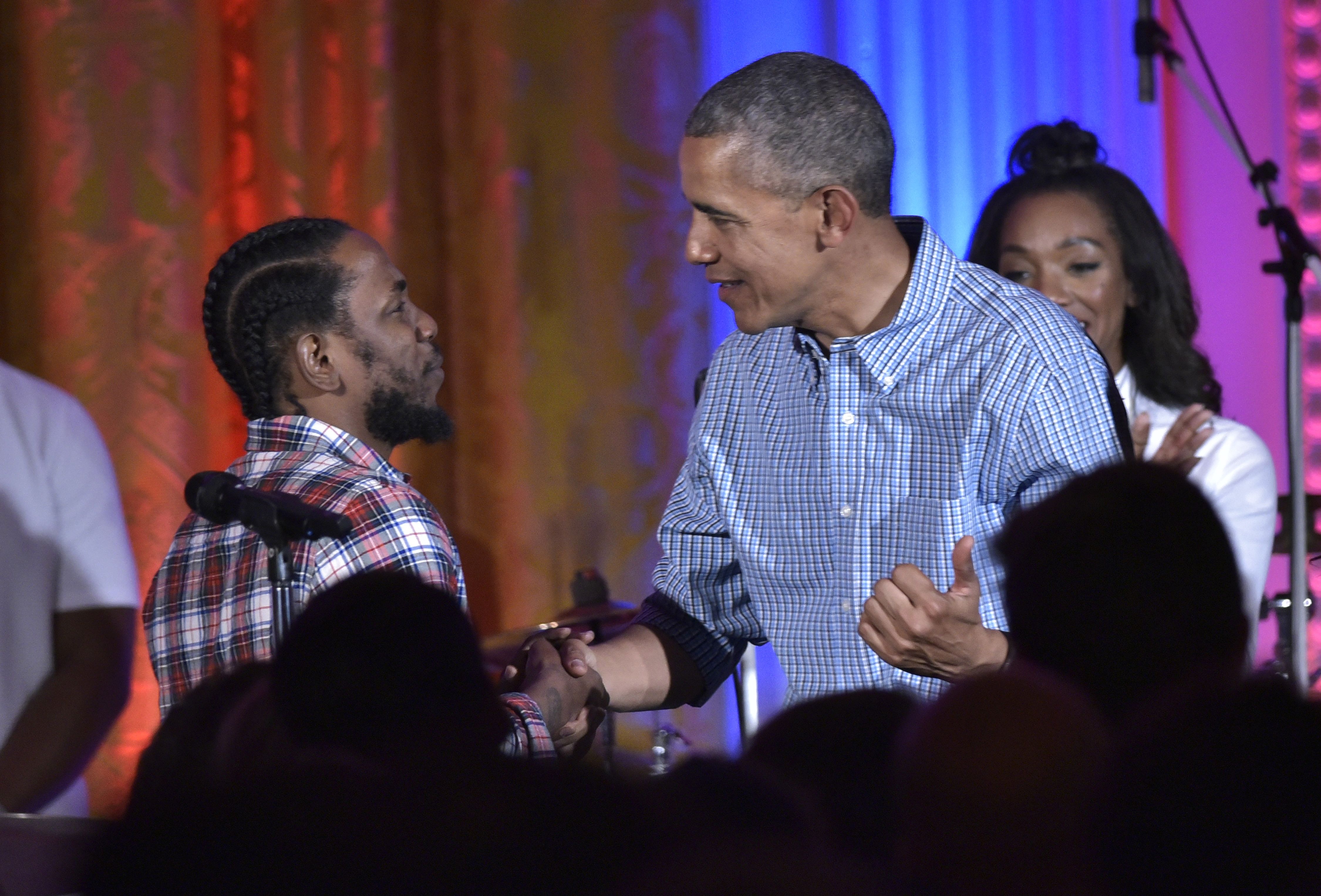 US President Barack Obama shakes hands with peformer Kendrick Lamar during an Independence Day Celebration for military members and administration staff on July 4, 2016 in the East Room of the White House in Washington, DC. (Mandel Ngan—Getty Images)