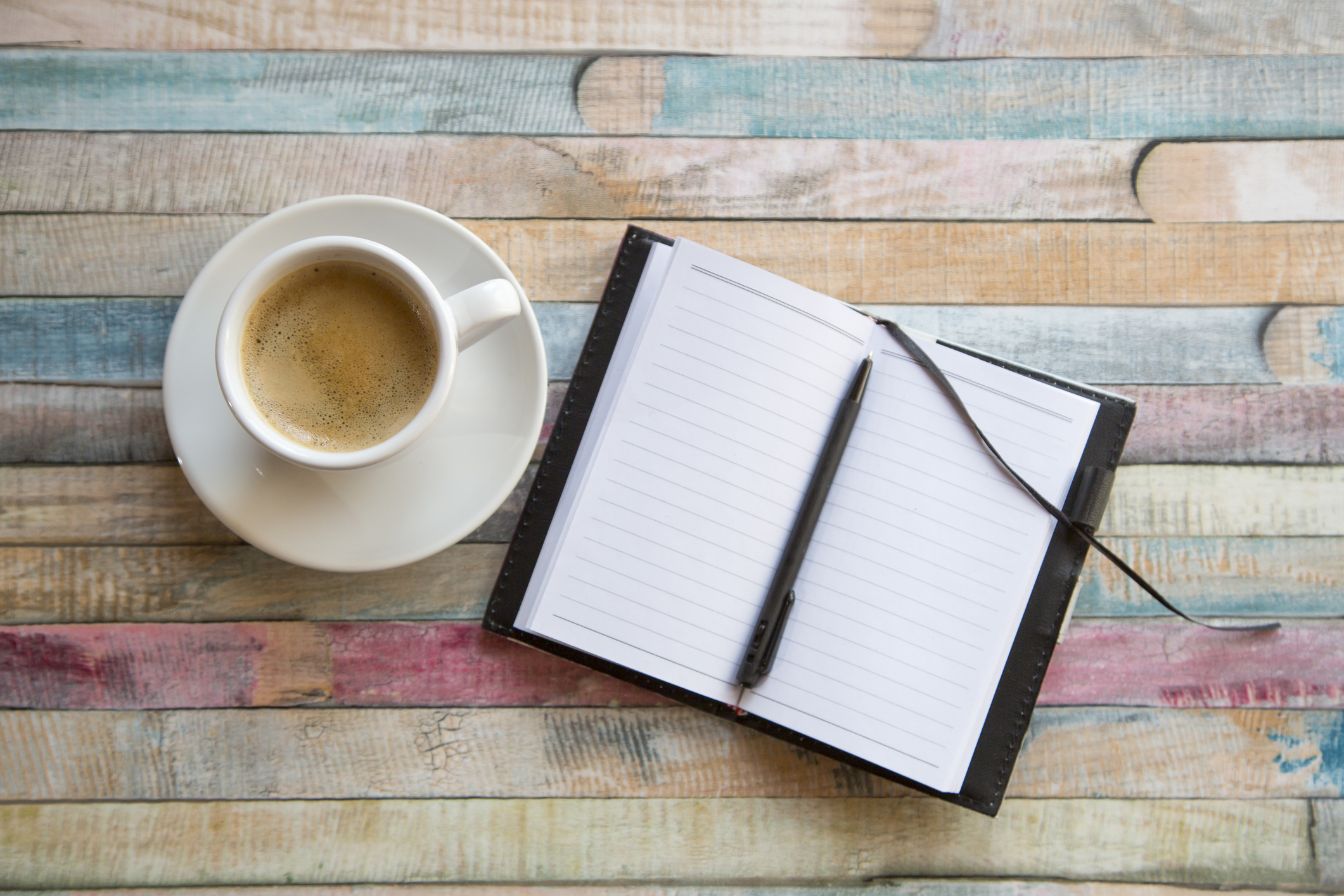 Cup of coffee and opened notebook