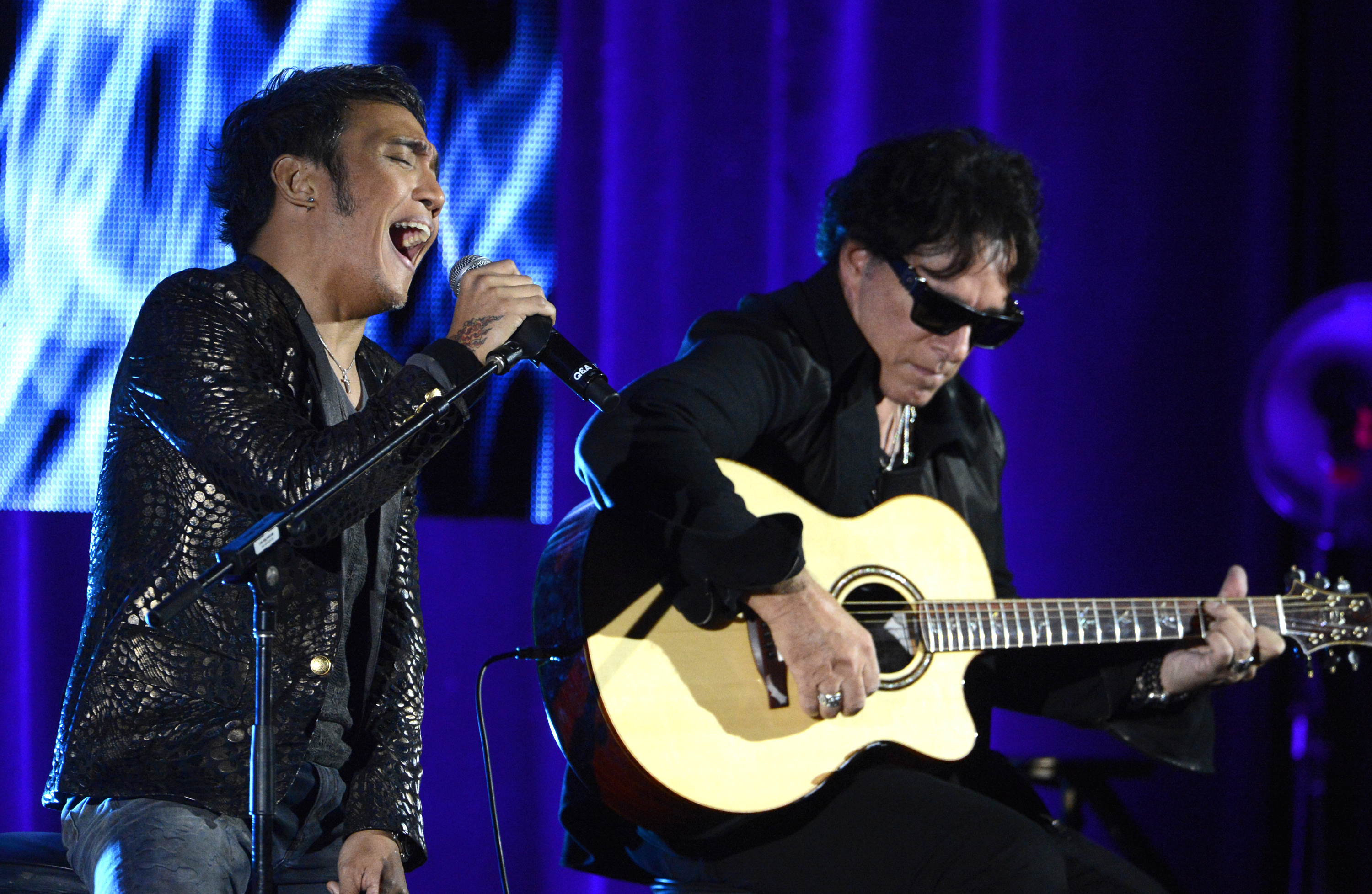 Arnel Pineda, left, and Neal Schon of rock band Journey perform during the PBS sessions at the Television Critics Association summer press tour in Beverly Hills, Calif., on August 6, 2013 (Phil McCarten—Reuters)