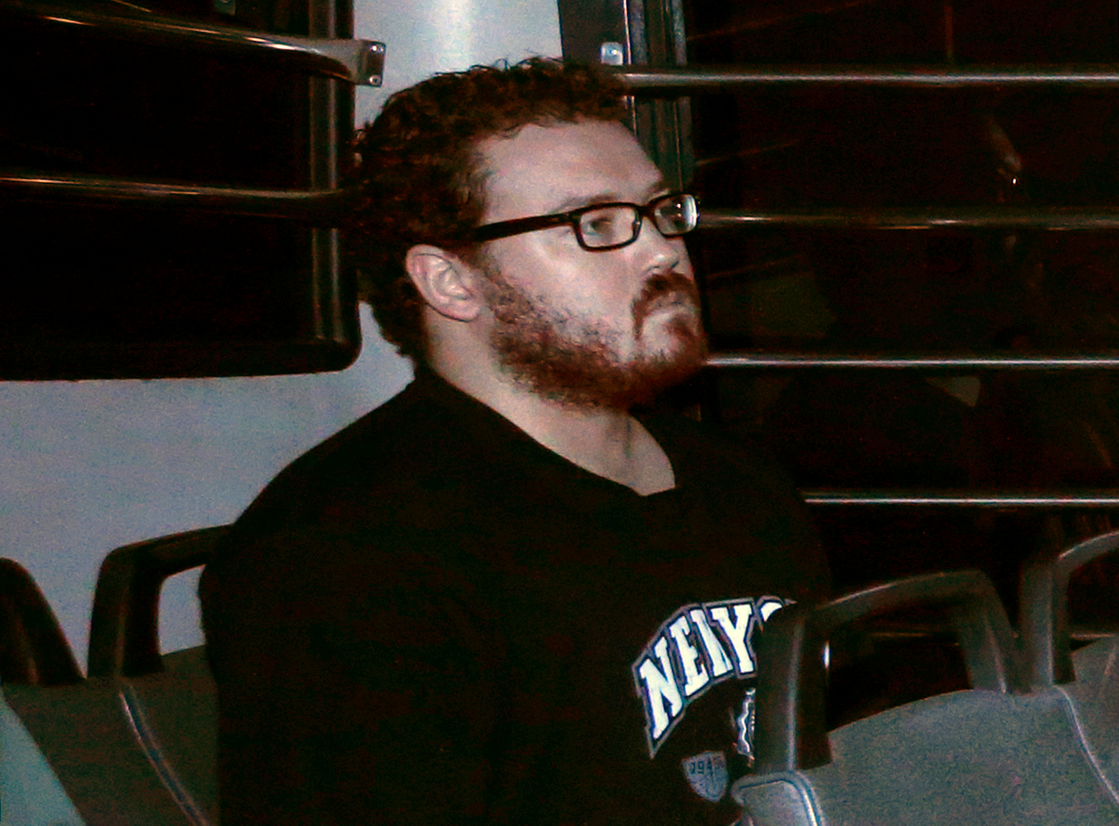 File photo of Jutting, a British banker charged with two counts of murder, sitting in the back row of a prison bus as he arrives at the Eastern Law Courts in Hong Kong