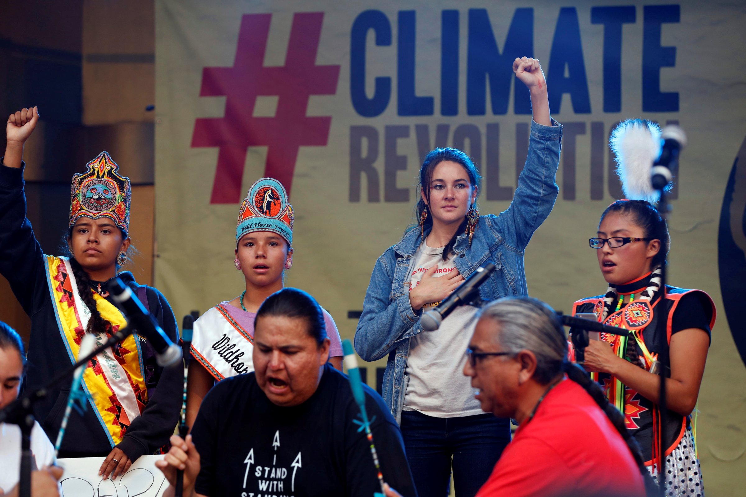 Actor Shailene Woodley stands with Native Americans on stage during a climate change rally in solidarity with protests of the pipeline in North Dakota at MacArthur Park in Los Angeles, California