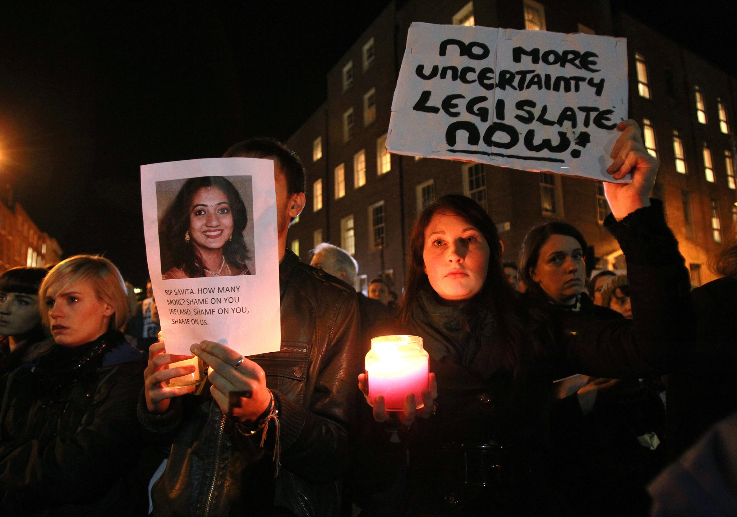 Protestors hold pictures of Savita Halappanavar, an Indian woman who was allegedly refused a pregnancy termination after doctors told her it was a Catholic country, as they gather outside the Parliament building during a demonstration in favor of abortion legislation in Dublin on Nov. 14, 2012. Halappanavar, who was 17 weeks pregnant, repeatedly asked the hospital to terminate her pregnancy because she had severe back pain and was miscarrying, her family said.