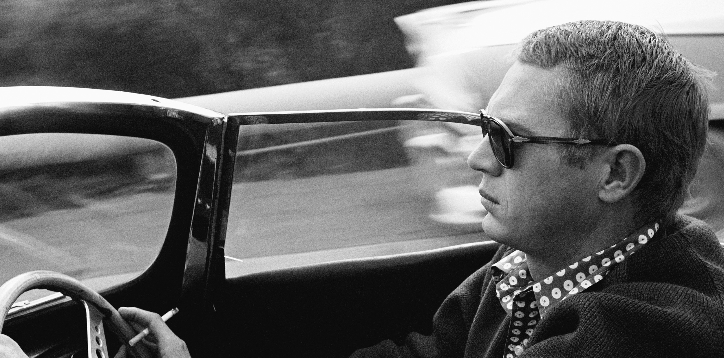 Steve McQueen traveling down Nichols Canyon in his 1957 Jaguar XKSS, 1960.