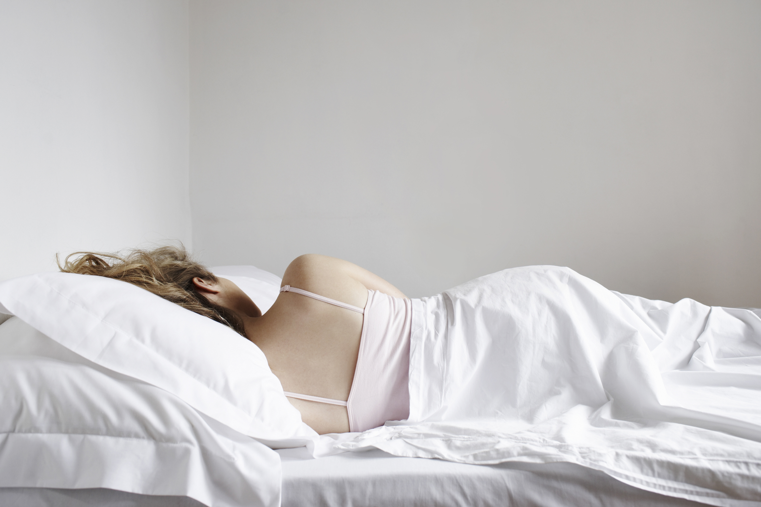 Portrait of woman sleeping in bed