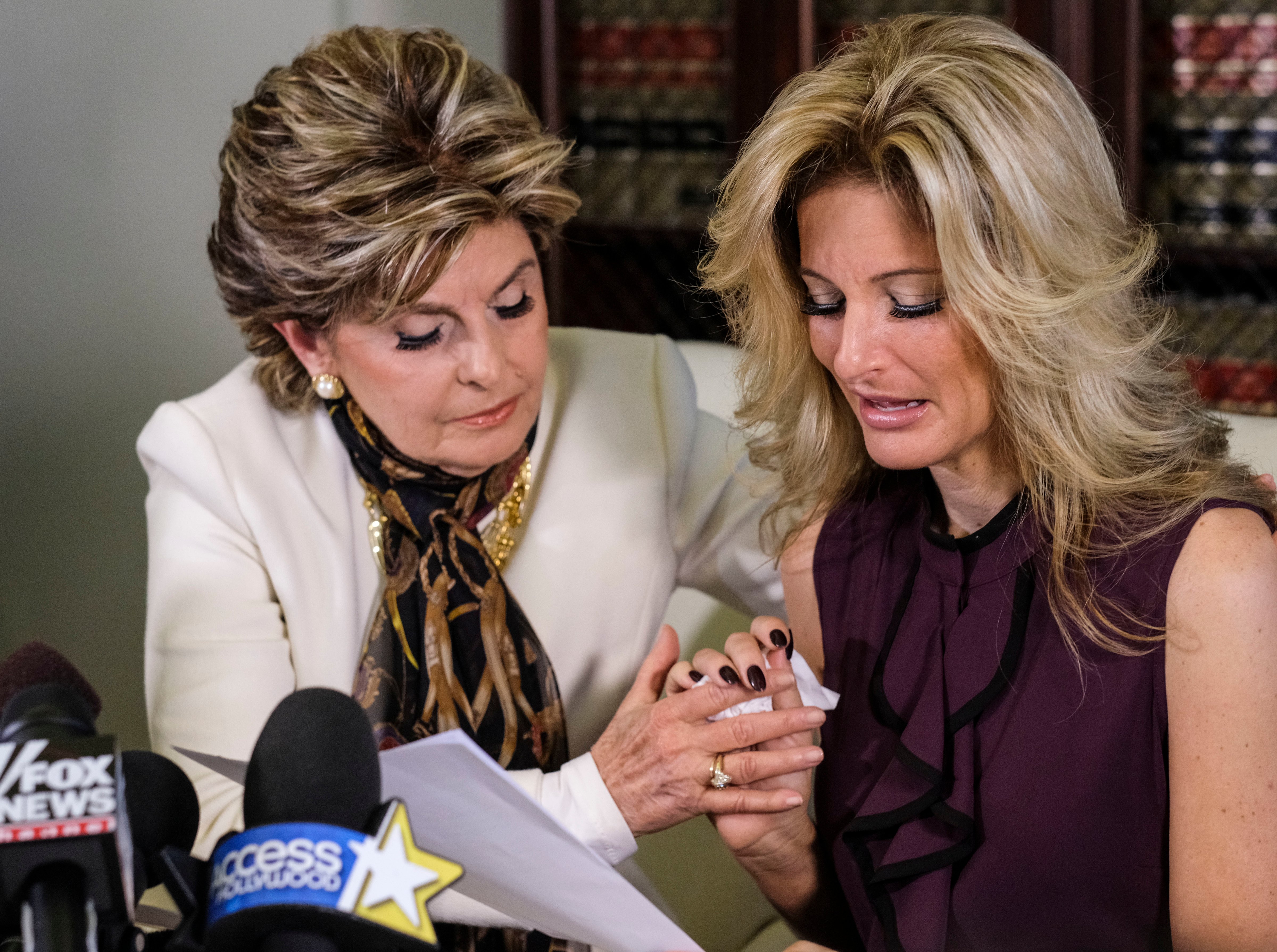 Attorney Gloria Allred, left, comforts Summer Zervos as the former "Apprentice" contestant reads a statement during a news conference on Oct. 14, 2016. (AP) (Ringo H.W. Chiu—AP)