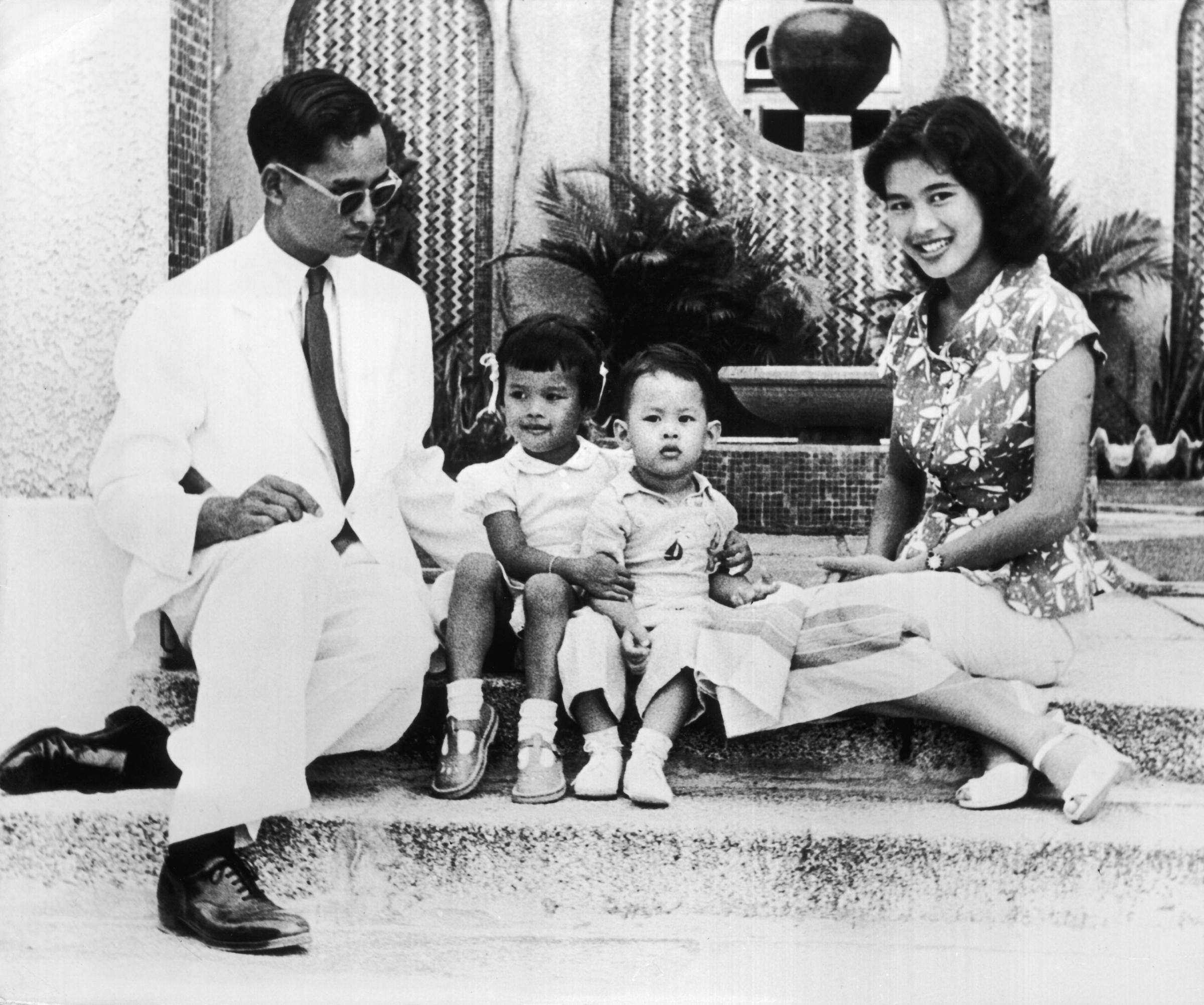 King Bhumibol Adulyadej with his wife Queen Sirikit and their children Crown Prince Maha Vajiralongkorn (right) and Princess Ubolratana Rajakanya in 1954.