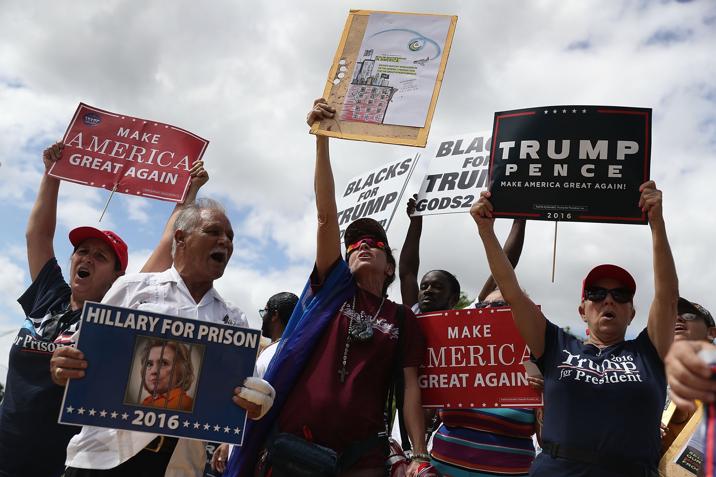 Supporters of Republican presidential nominee Donald Trump show their support for him before the start of the campaign event for Democratic presidential nominee Hillary Clinton at the Miami Dade College - Kendall Campus, Theodore Gibson Center on October 11, 2016 in Miami, Florida.