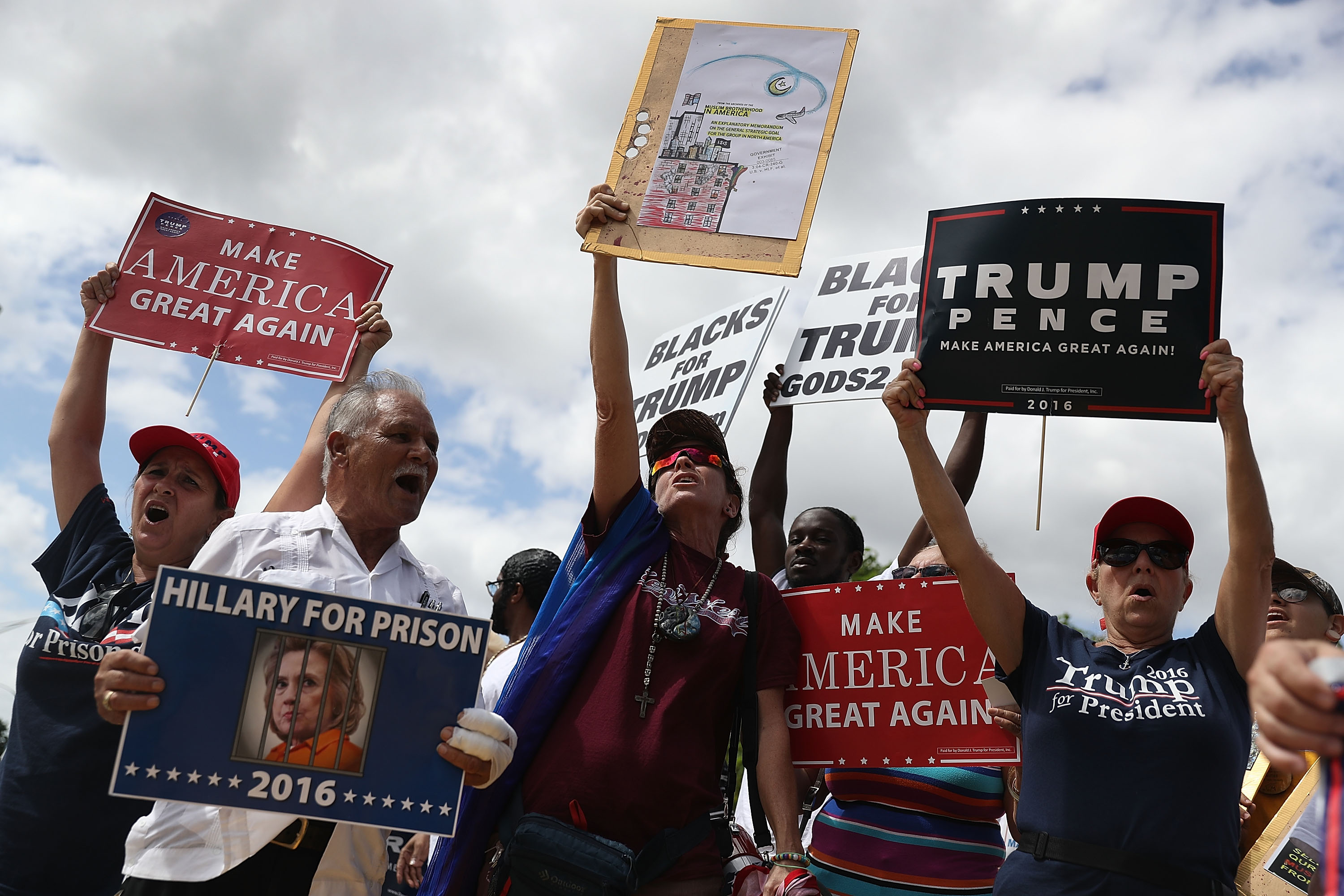 Supporters of Republican presidential nominee Donald Trump show their support for him before the start of the campaign event for Democratic presidential nominee Hillary Clinton at the Miami Dade College - Kendall Campus, Theodore Gibson Center on October 11, 2016 in Miami, Florida. (Joe Raedle—Getty Images)