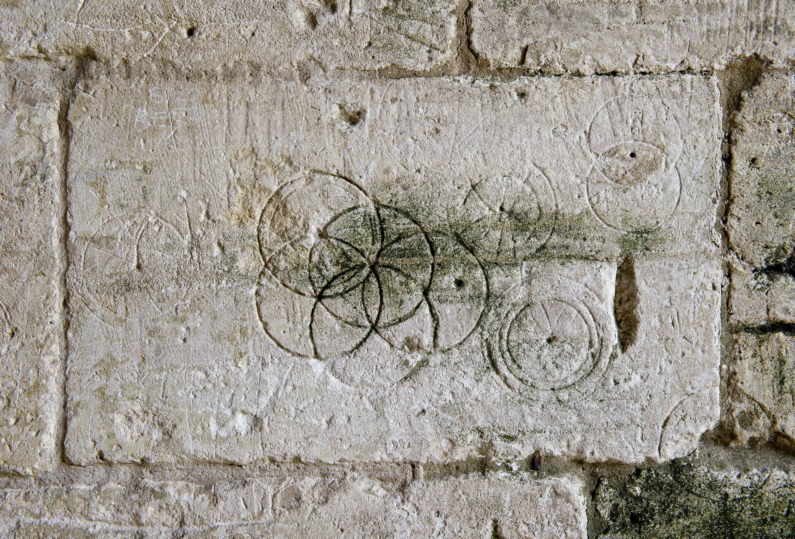 Daisy-Wheels inscribed with a pair of compasses or dividers found in Saxon Tithe barn, Bradford-on-Avon. (Peter Williams—The Historic England Archive, Hi)